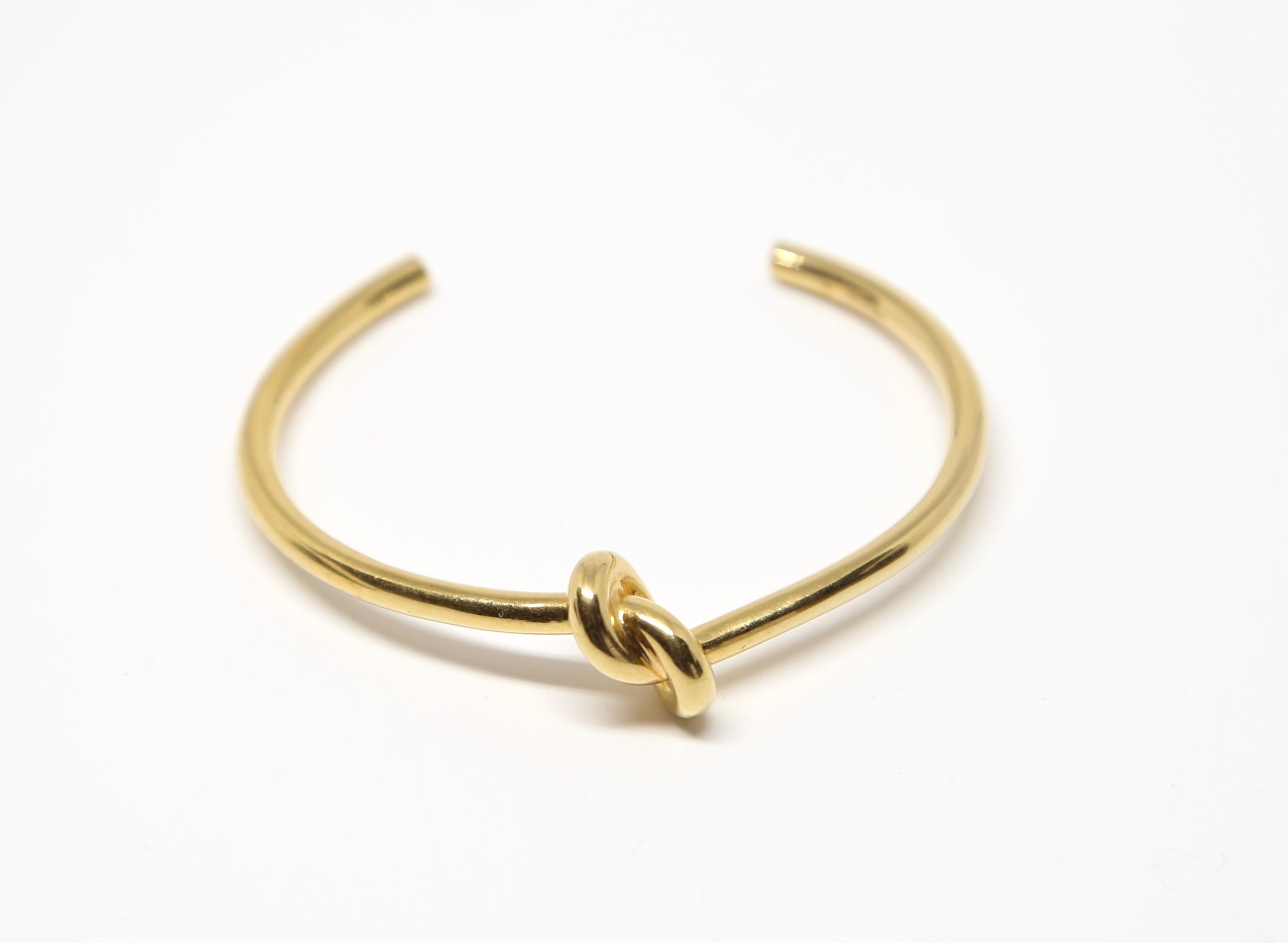 Yellow gold-tone, thin bracelet with knot motif designed by Phoebe Philo for Celine. Size M. Fits a wrist 5.75