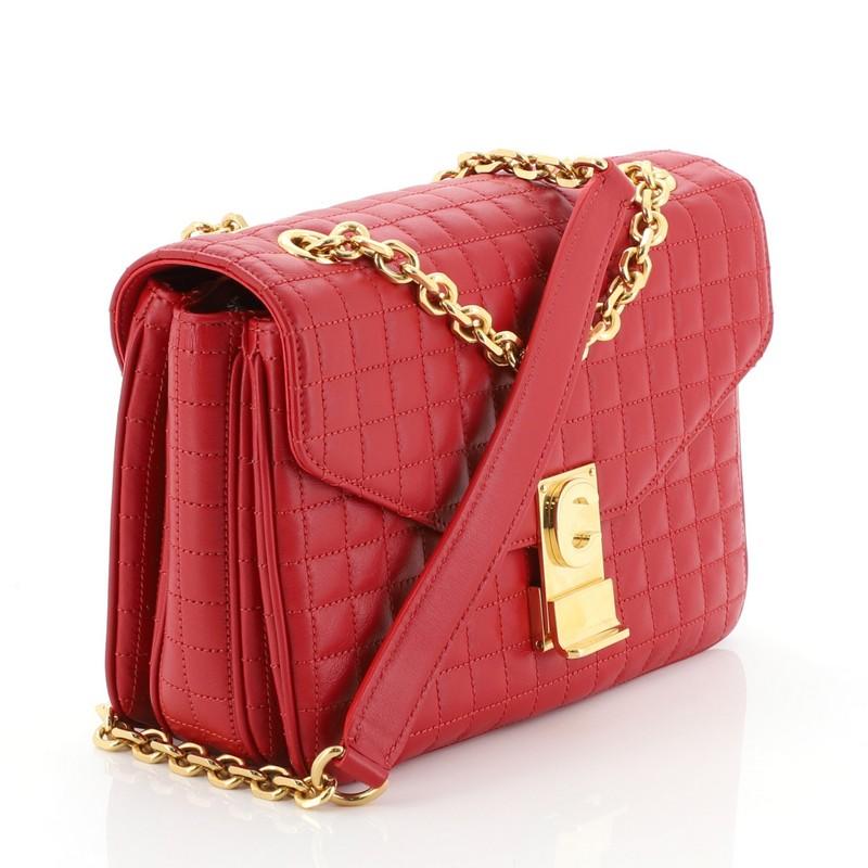 This Celine C Bag Quilted Leather Medium, crafted from red quilted leather, features a sliding chain strap with leather pad and gold-tone hardware. Its clasp closure opens to a red leather interior with three open compartments and side zip and slip