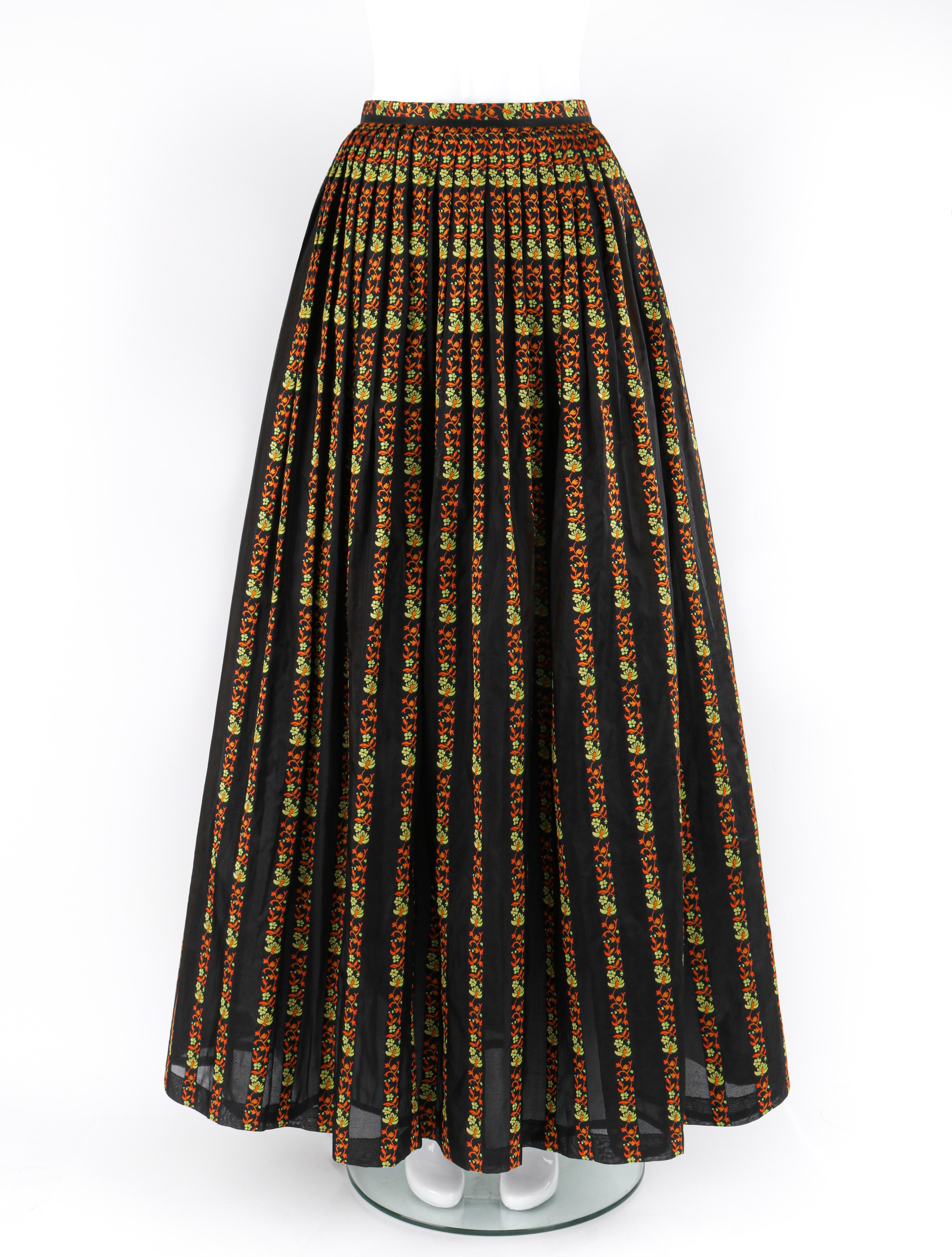 Brand / Manufacturer: Celine
Circa: 1970s
Designer: Celine Vipiana
Style: Maxi circle skirt
Color(s): Shades of black, orange, green
Lined: Yes
Marked Fabric Content: 