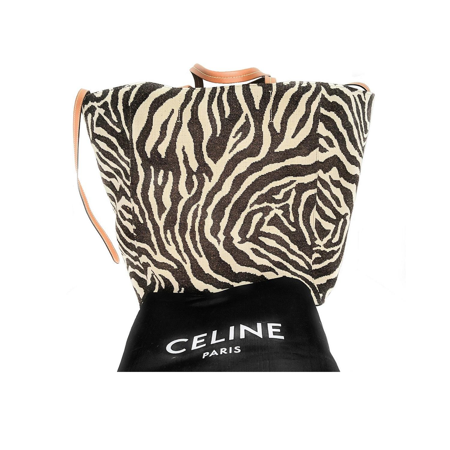 Cabas Phantom bag by Celine in wool and silk blend with all-over zebra motif. Leather handles and self-tie straps with contrasting stitching, zebra-printed canvas lining, one leather zip pocket and two small slip pockets.

Designer: Celine
Material: