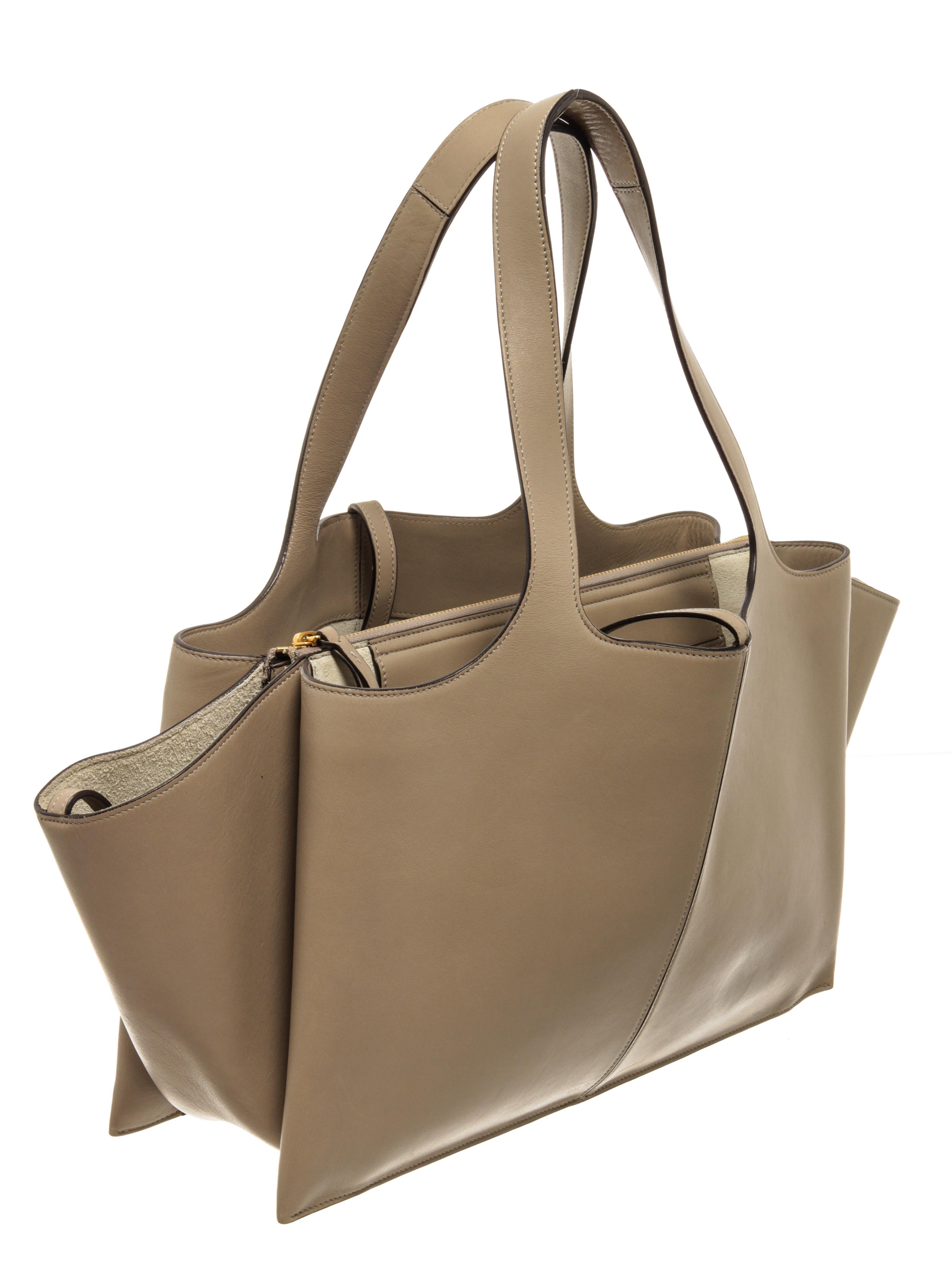Celine Calfskin Leather Trifold Shoulder Bag with gold-tone hardware, stitch trim, three compartments with one zipped, broken white suede lining, interior leather slip pockets, dual leather shoulder straps, and open closure. 

79247MSC.