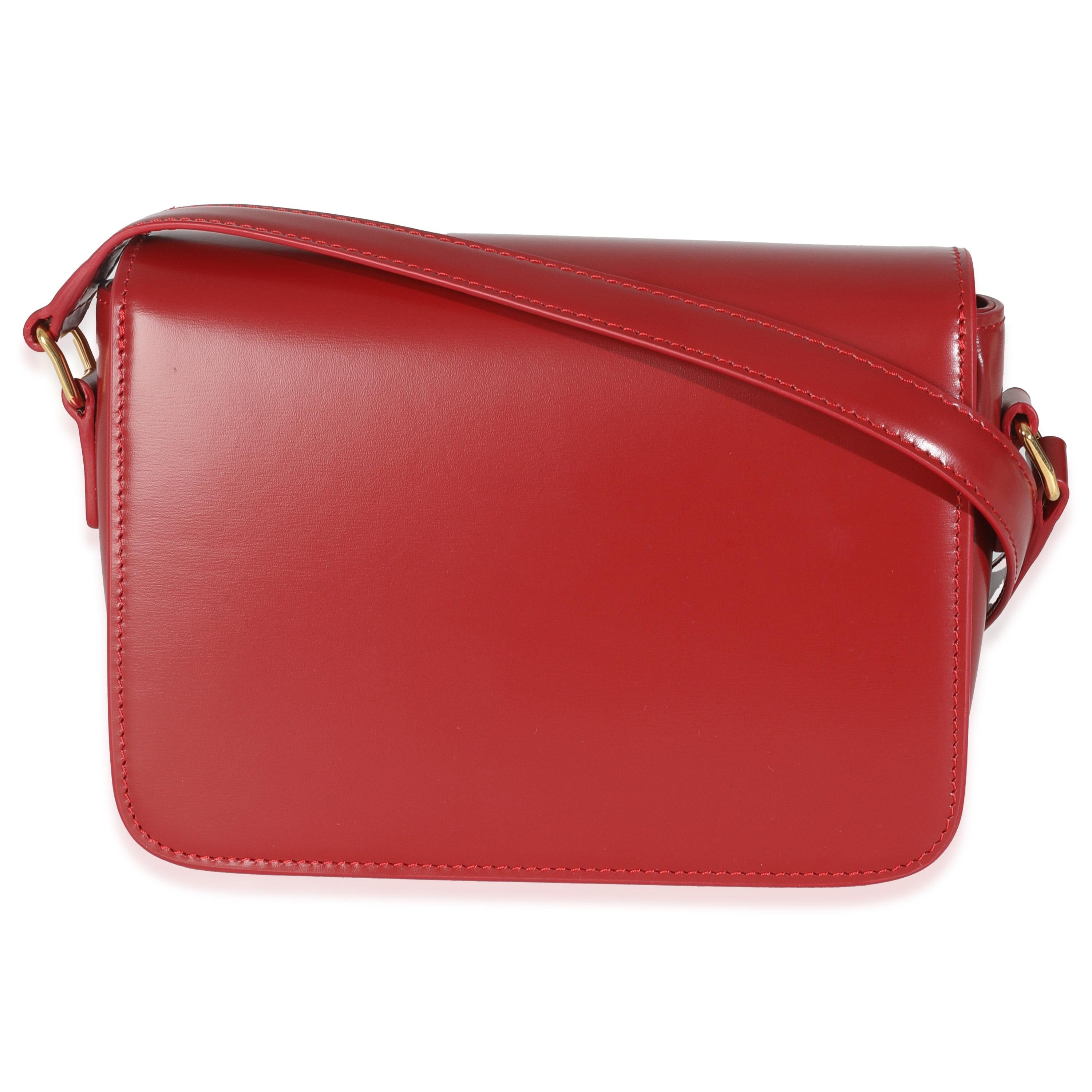 Listing Title: Celine Carmin Shiny Calfskin Teen Triomphe Bag
SKU: 146906
MSRP: 4050.00 USD
Condition: Pre-owned 
Handbag Condition: Excellent
Condition Comments: Item is in excellent condition and displays light signs of wear. Hairline scratching