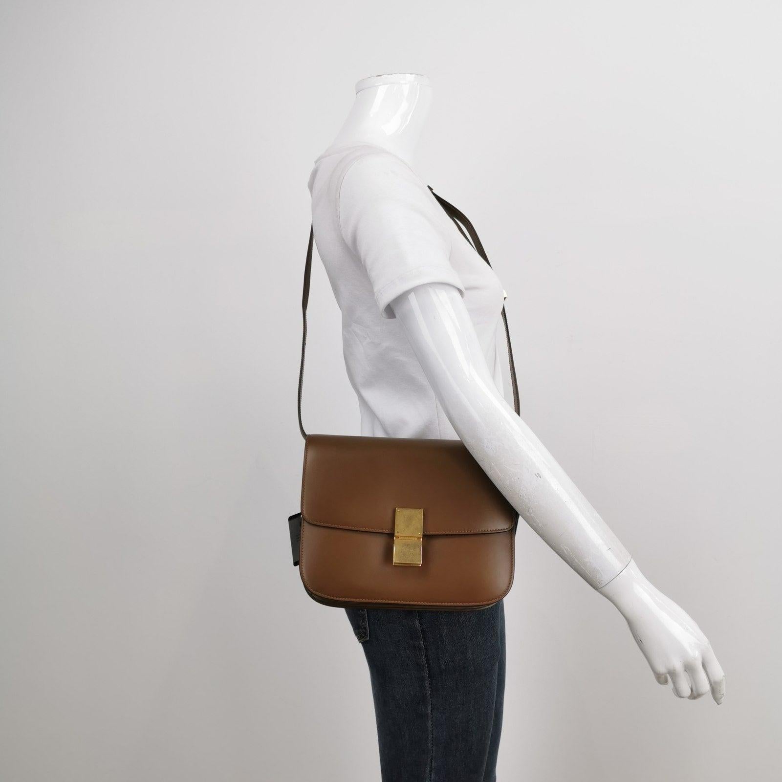 CELINE Classic Box Flap Caramel Brown Leather crossbody bag These are professional photos of the actual bag offered by Luxbags. This CELINE Classic Flap Grey Box Leather crossbody bag has a perpetually stylish design and roomy and easy-to-organise