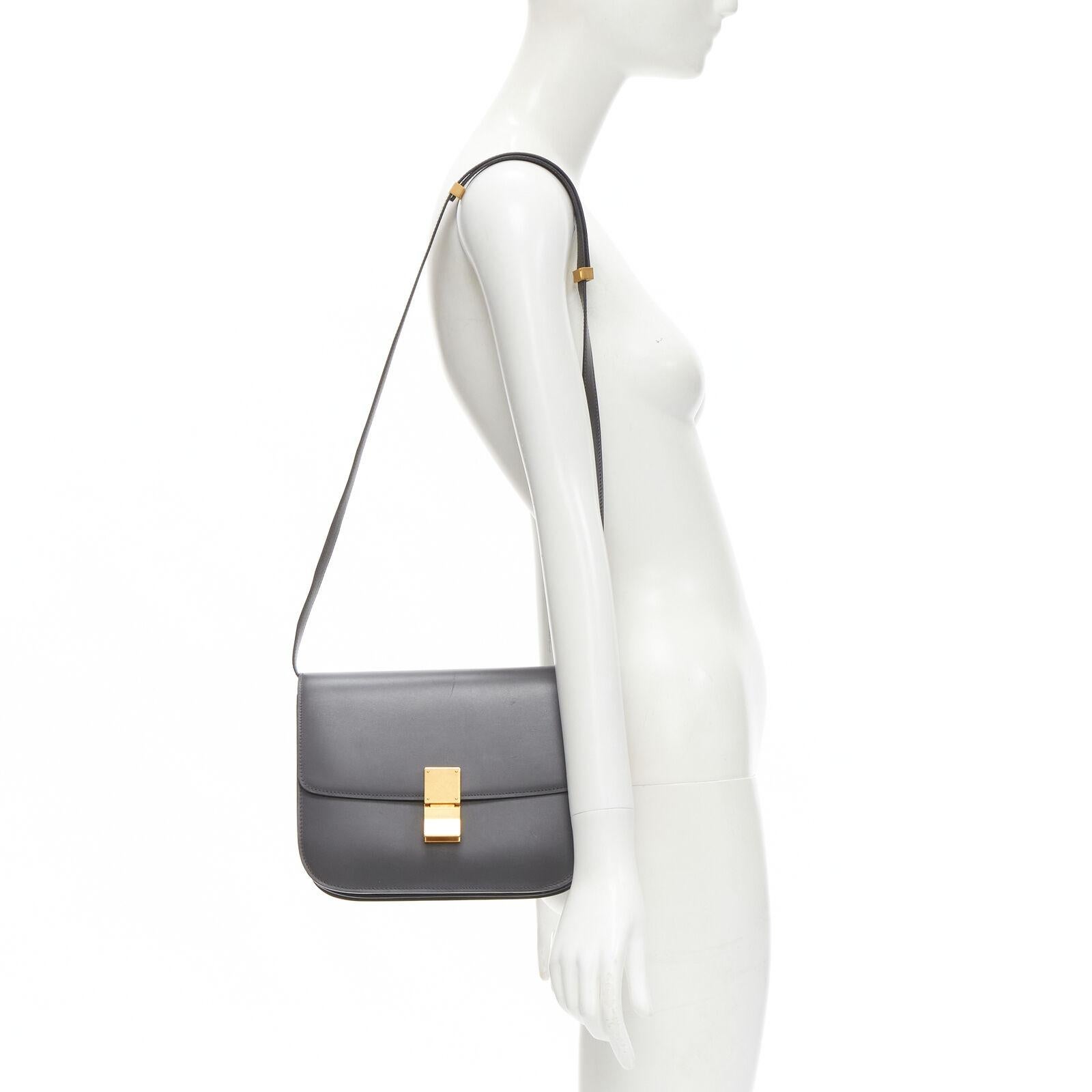 CELINE Classic Box grey calfskin leather buckle bag medium
Reference: KEDG/A00244
Brand: Celine
Designer: Phoebe Philo
Model: Classic Box
Material: Calfskin Leather
Color: Grey, Gold
Pattern: Solid
Closure: Push Clasp
Lining: Leather
Extra Details: