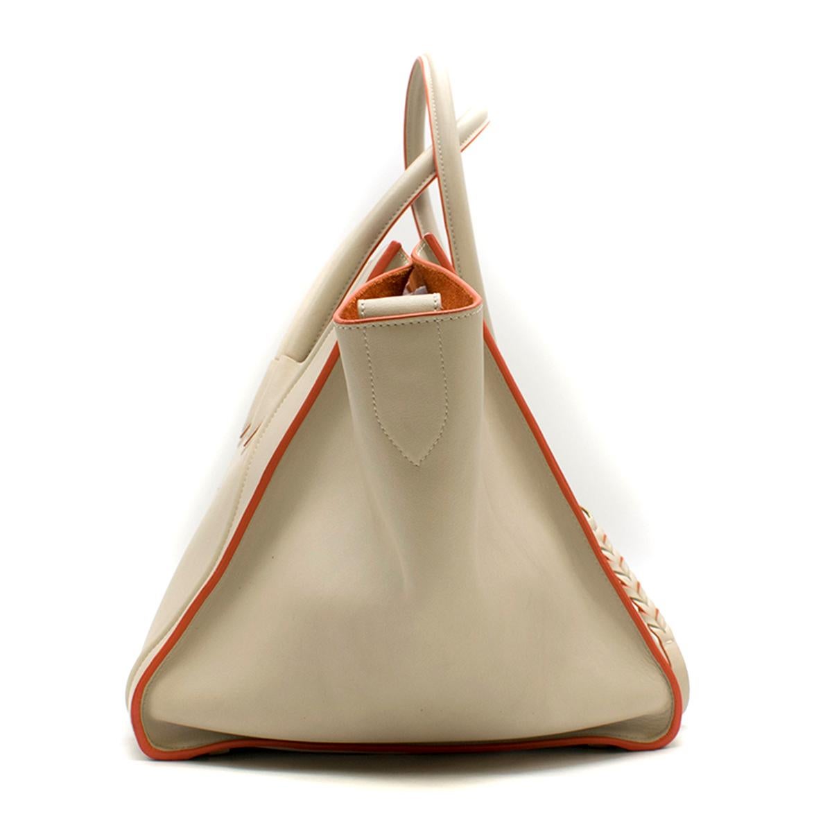 Celine Cream and Orange Calfskin Medium Luggage Phantom Bag

-Cream phantom bag with orange piping
-Two rolled leather top handles
-One exterior zipped pocket with braided zip pull
-One main interior pocket with one zipped pocket
-Celine embossed on