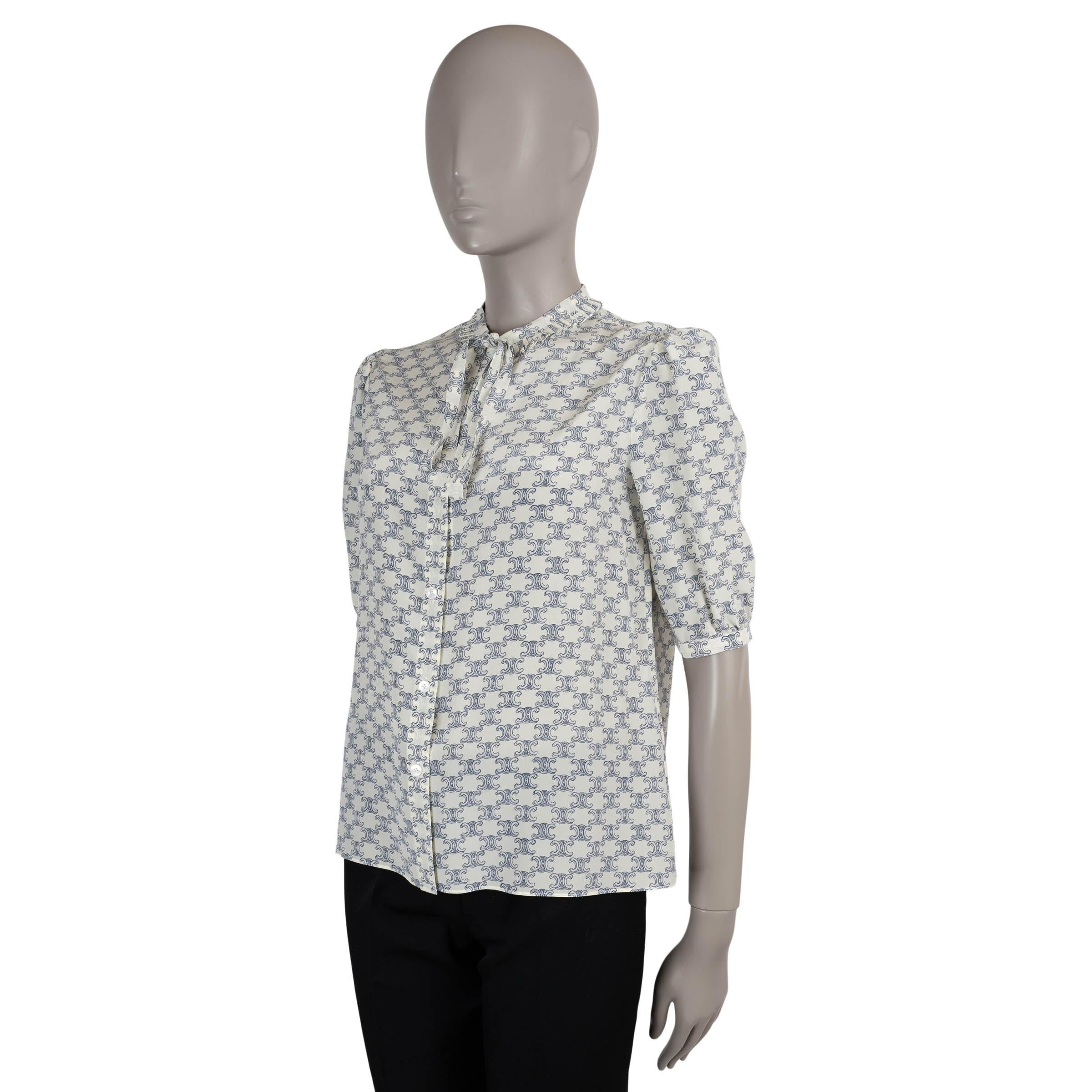 This 100% authentic Celine blouse is crafted in cream crepe silk (content tag missing) with a light blue all-over Triomphe print. It features a classic fit, delicate ruffled collar with a fine tied lavallière bow, and short puff sleeves for a