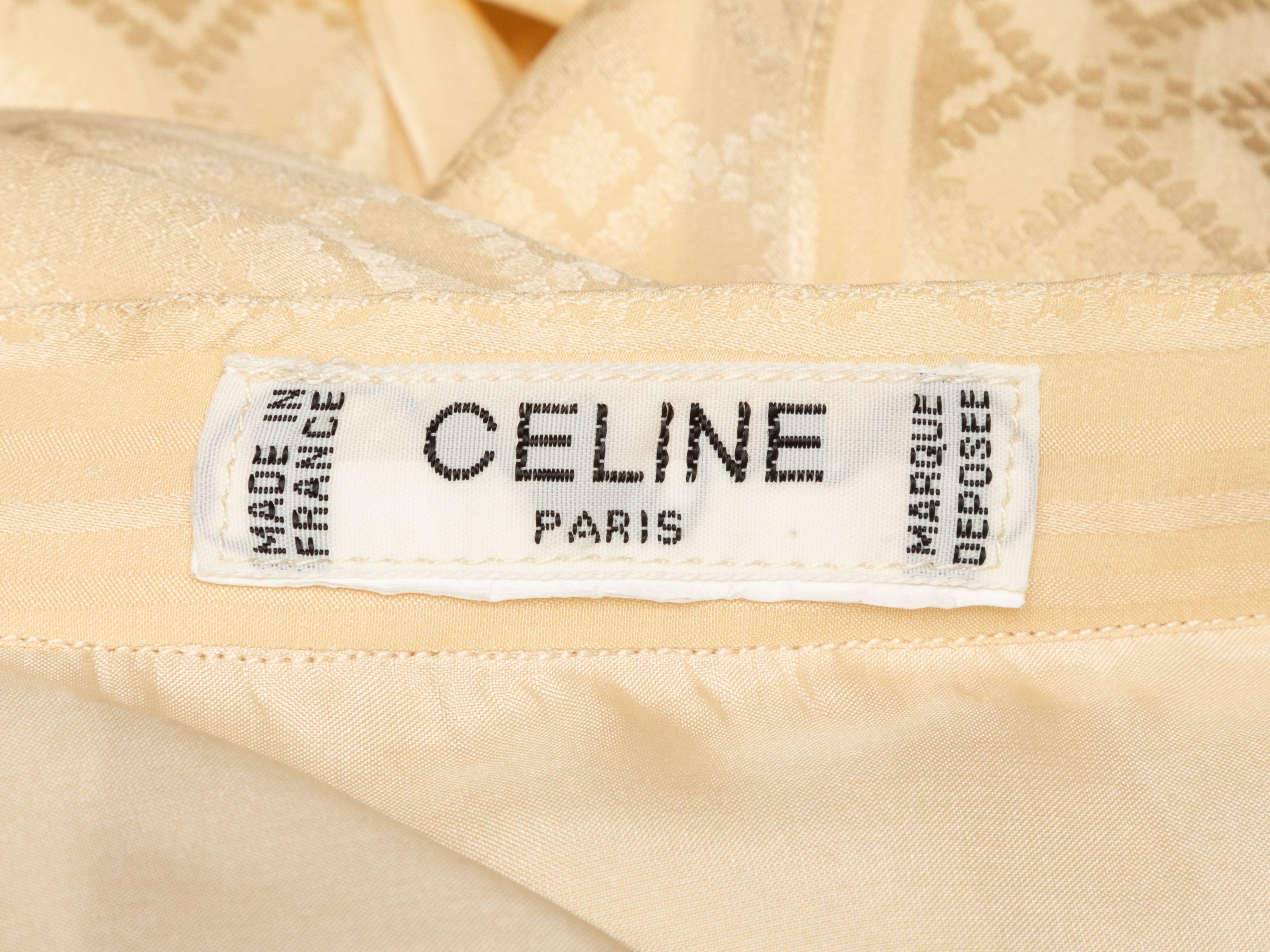 Product Details: Vintage cream clover patterned pleated silk skirt by Celine. Zip closure at back. 27
