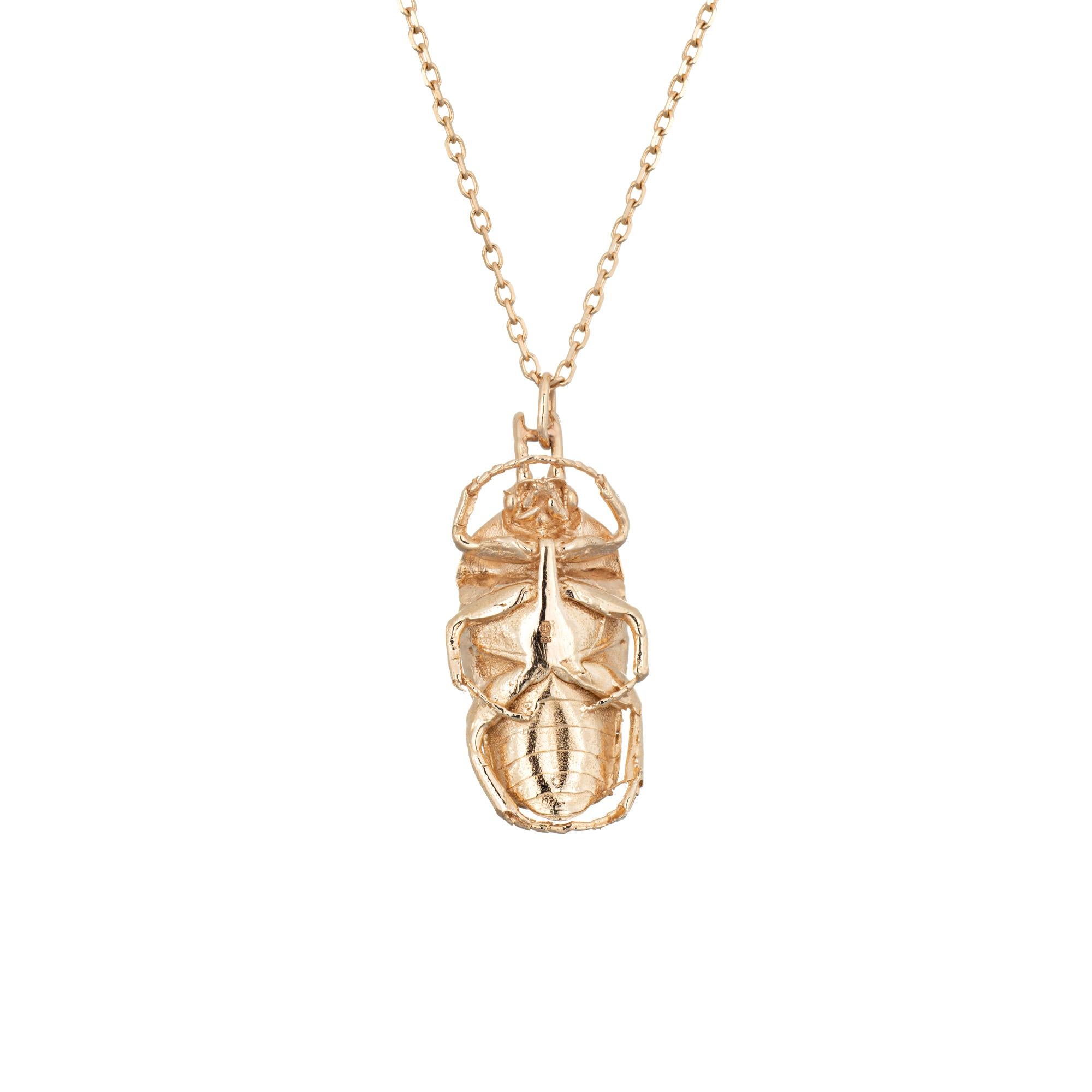 Stylish and finely detailed contemporary diamond set scarab necklace crafted in 14 karat white gold. 

Trillion cut diamond is estimated at 0.06 carats (estimated at I-J color and I1 clarity).  

The scarab is a protective charm, promoting luck and