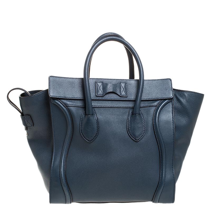 The Mini Luggage tote from Celine is one of the most popular handbags in the world. This tote is crafted from leather and designed in a dark blue shade. It comes with rolled top handles and a front zip pocket. The bag is equipped with a well-sized