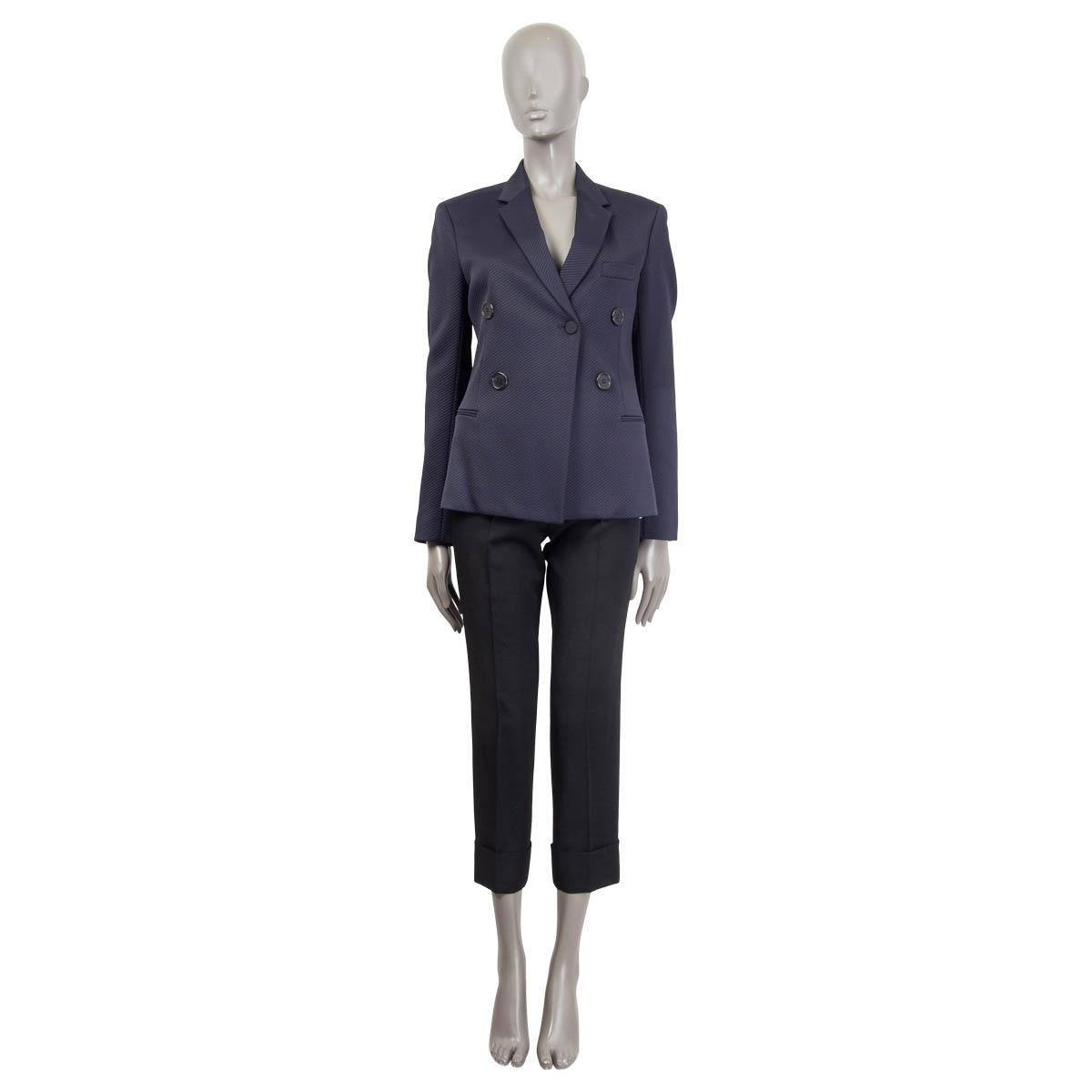 100% authentic Celine double-breasted jacket in midnight blue viscose (96%) and elastane (4%). Features two faux front slit pockets and buttoned cuffs. Opens with one button on the front. Semi-lined in midnight blue silk (100%). Has been worn and