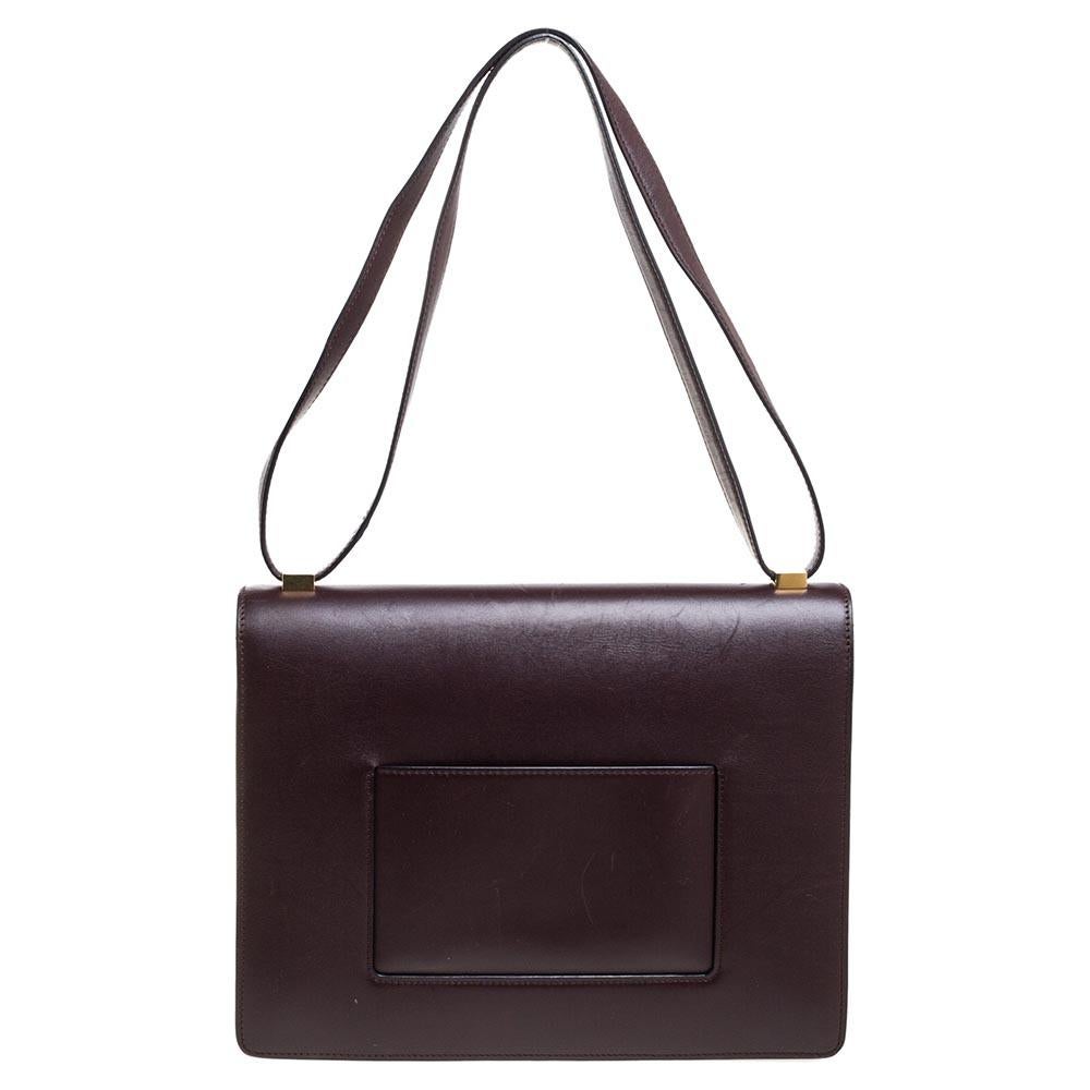 This fabulous leather and suede bag is artistically designed to help express your style. The bag has gold-tone hardware and a shoulder handle. Its leather interior is well-sized, making the bag both stylish and practical. This Celine bag is an
