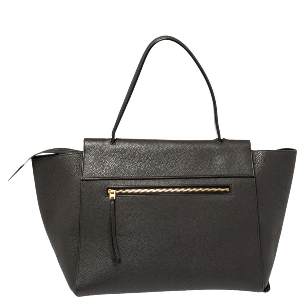 Bags from Celine are symbols of excellent craftsmanship and timeless design. This dark grey creation has been crafted from leather and styled with a front flap and belt details. It flaunts a single top handle, a zip pocket at the back, and a