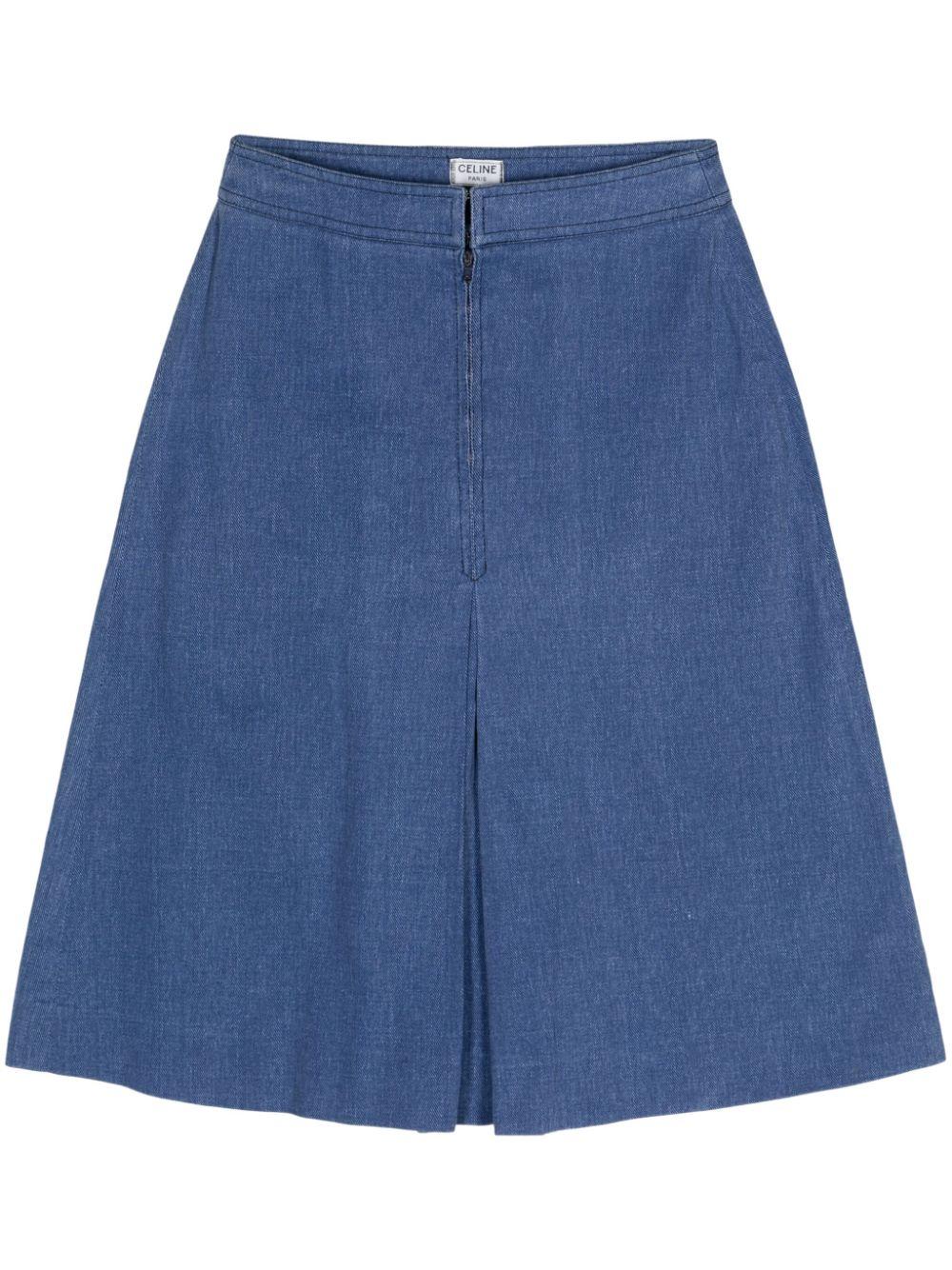 1970s Celine Denim skirt featuring indigo blue cotton denim, high-waisted, a gold-tone 