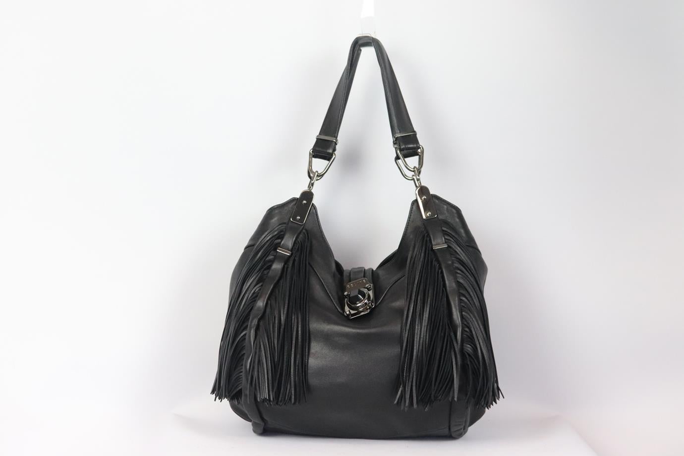 Celine Dimitri fringed leather shoulder bag. Black. Push lock fastening at front. Does not come with dustbag or box. Height: 13 in. Width: 15.5 in. Depth: 5.5 in. Handle Drop: 9.5 in. Very good condition - Light wear along the edges at base. Some