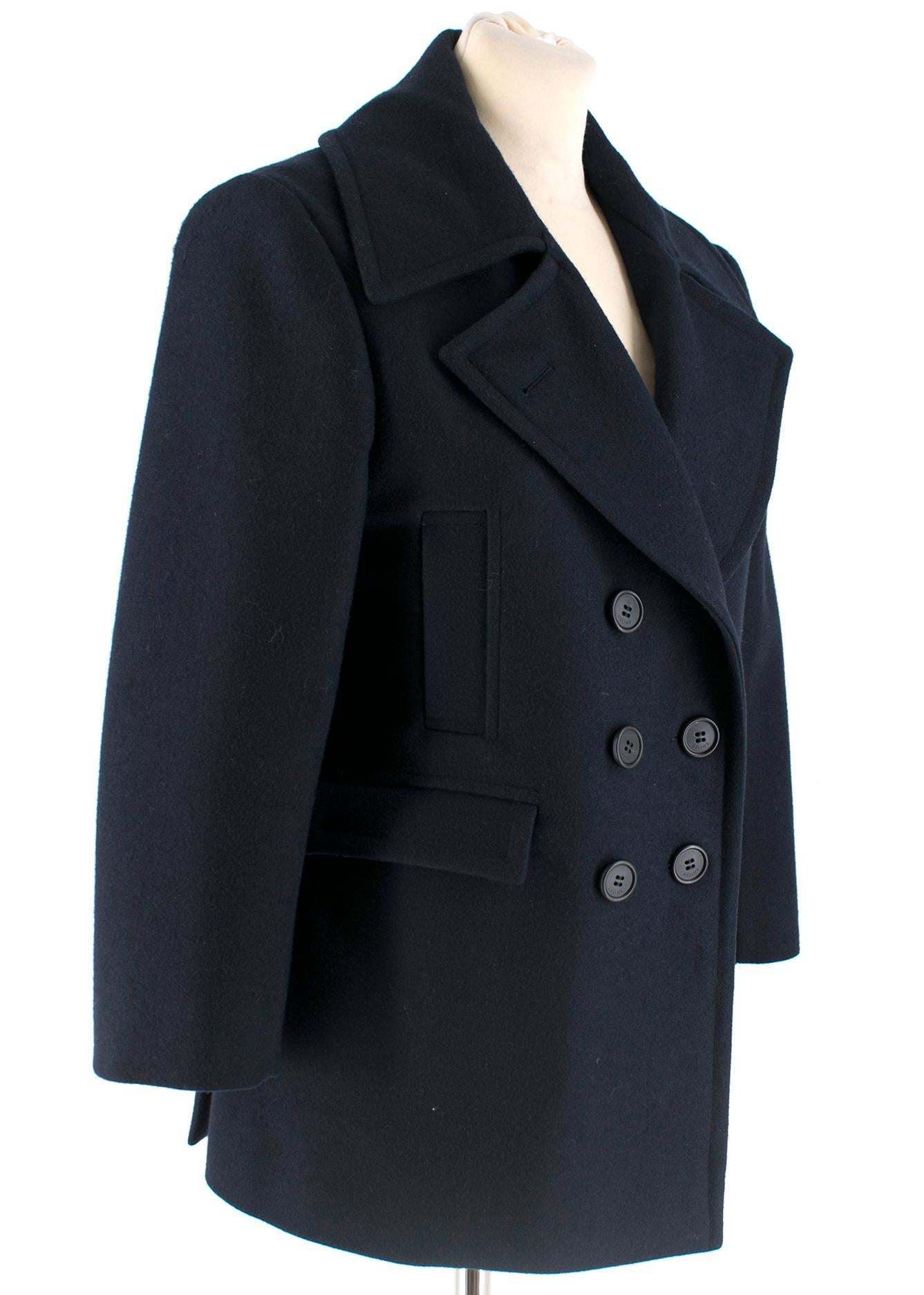 Celine Double Breasted Wool Navy Coat 

Short, straight double breasted genuine wool coat with four front pockets in a dark blue colour. Can be worn  fully buttoned up or with one button down as in the pictures.

- 100% Wool
- Body lining: 100%