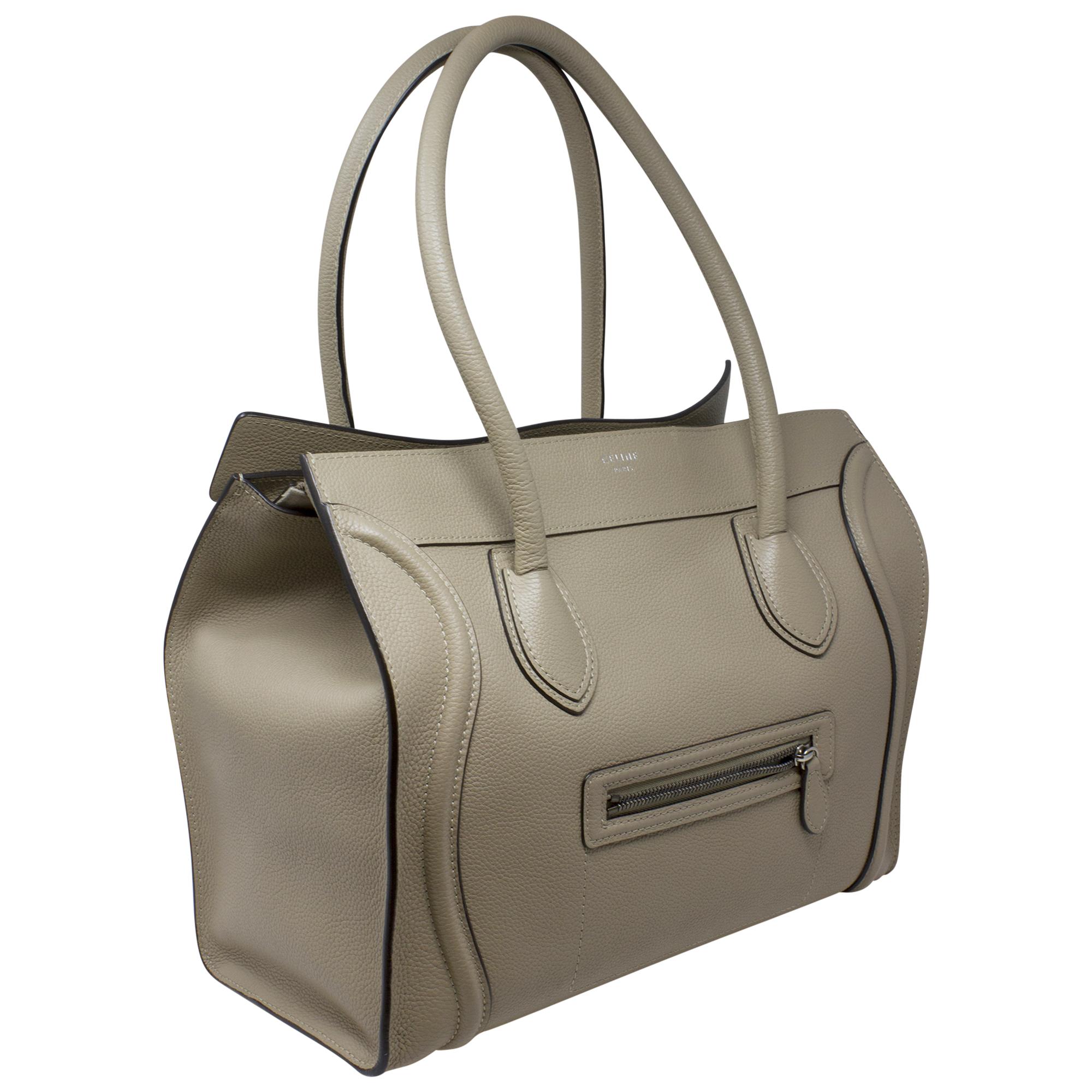 Introducing the Celine Dune Grained Leather Tote, a timeless essential for the modern woman. Crafted from luxurious dune grained leather, this tote exudes understated elegance and sophistication. With its minimalist design and silver hardware