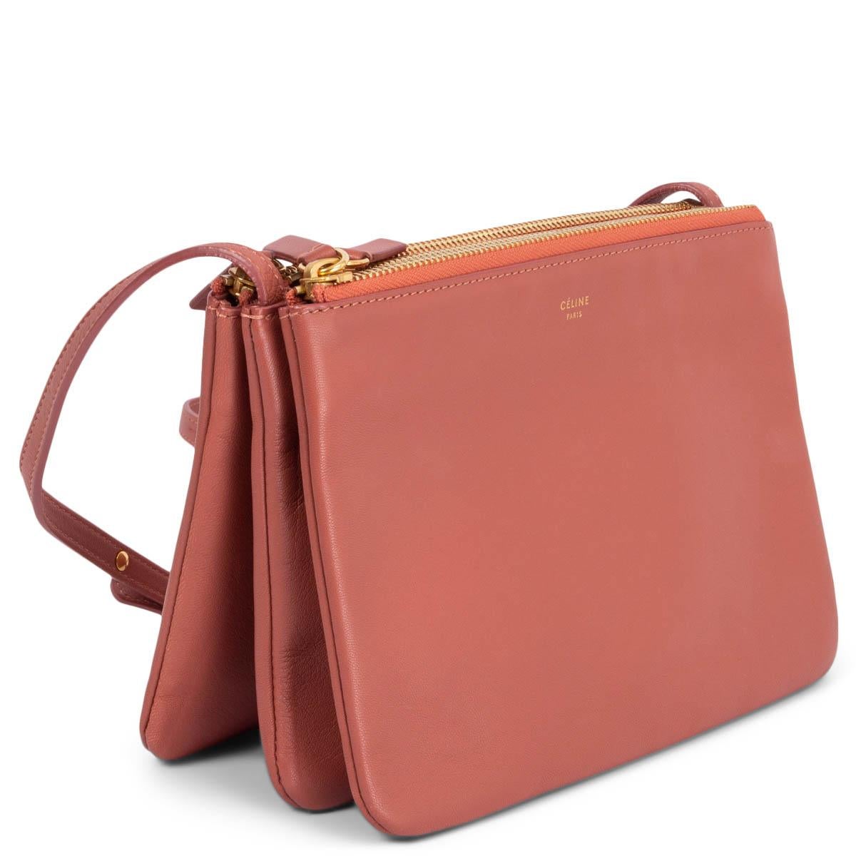 100% authentic Céline Trio Small shoulder bag in dusty rose lambskin. Can be carried cross-body or on your shoulder. Three separate zipper compartments attached together with snap-buttons. Lined in grey jersey. Can be carried as a clutch by