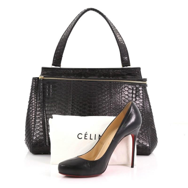 This Celine Edge Bag Python Medium, crafted in genuine black python skin, features single looped shoulder strap, Celine stamped logo at the front, exterior snap pocket, and gold-tone hardware. Its zip closure opens to a black leather interior with