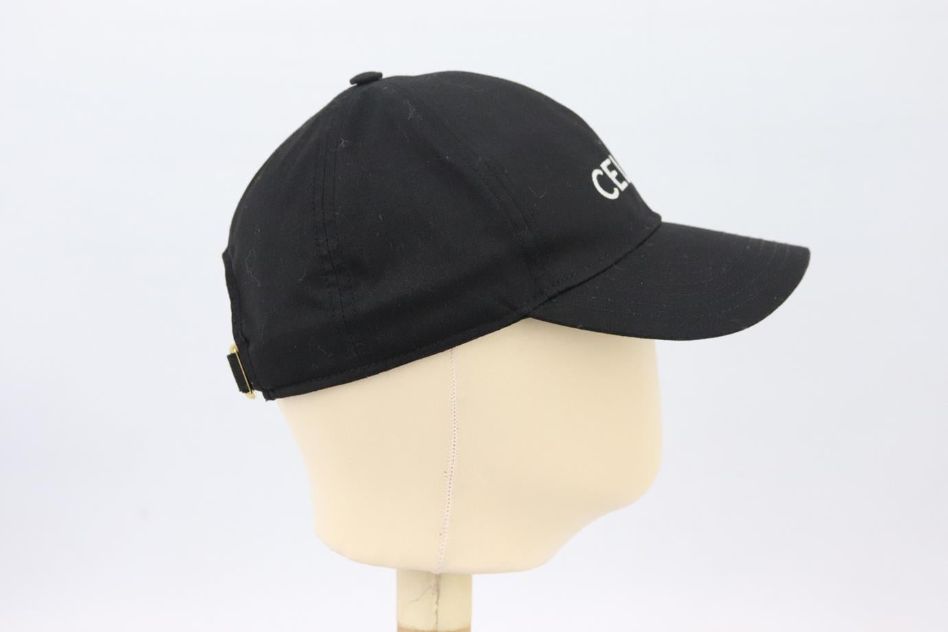 Celine embroidered cotton twill baseball cap. Made from black cotton-twill with white logo-embroidery on the front. Black. Buckle fastening at back. 65% Polyester, 35% cotton. Size: One Size. Brim Depth: 2.75 in. Circumference: 21.4 in