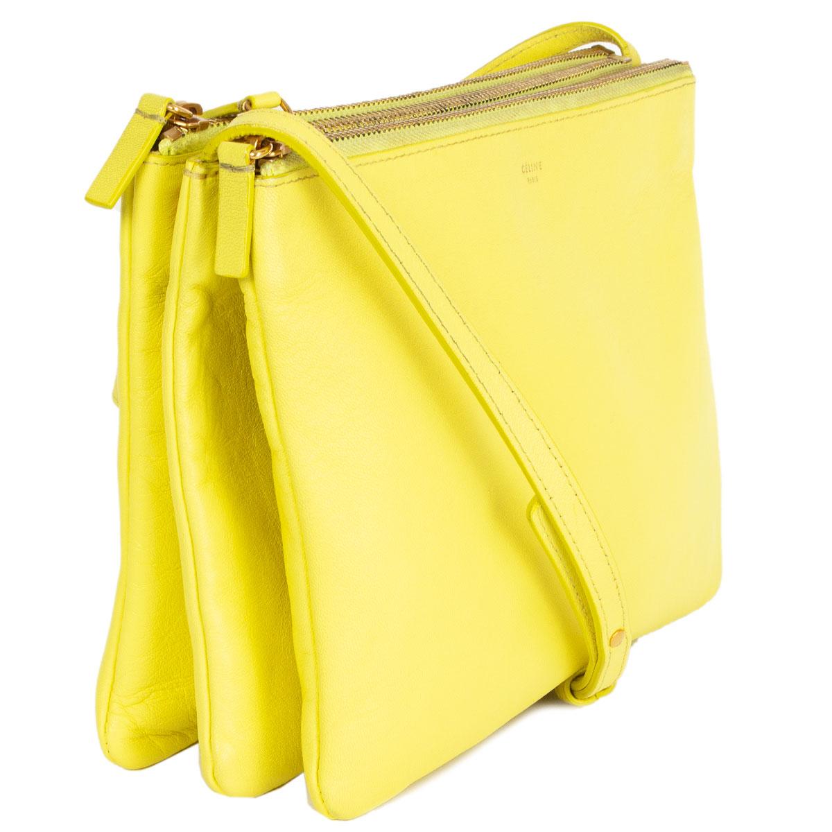 100% authentic Céline Trio Large shoulder bag in fluo yellow lambskin. Can be carried cross-body or on your shoulder. Three separate zipper compartments attached together with snap-buttons. Lined in grey jersey. Can be carried as a clutch by