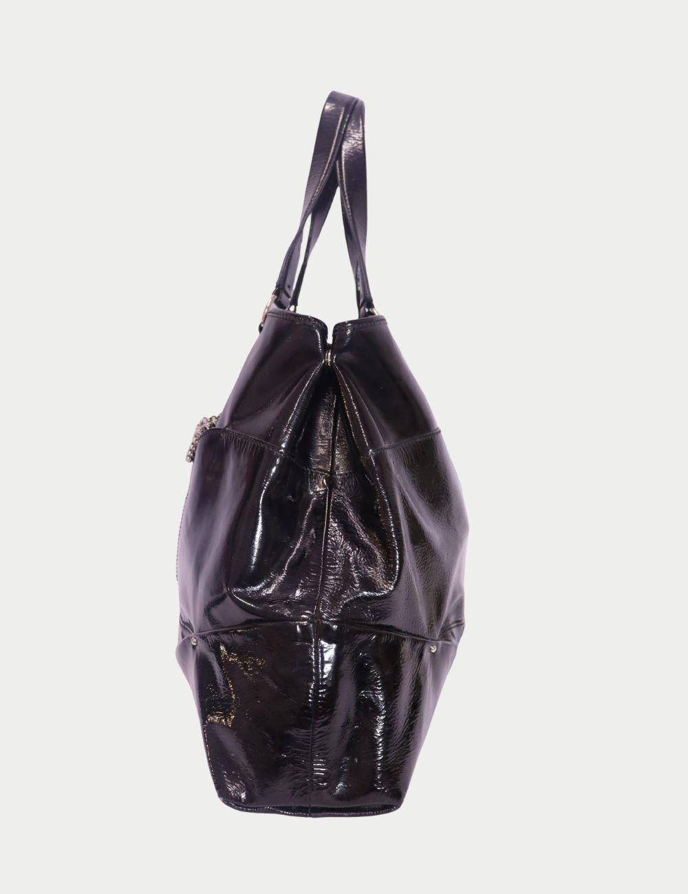 Celine Black Patent Leather Hobo Tote with Chain Detail

Effortlessly chic and ultra-spacious, this Celine black patent leather hobo tote is a luxe essential for everyday sophistication. Crafted from glossy patent leather, this oversized tote