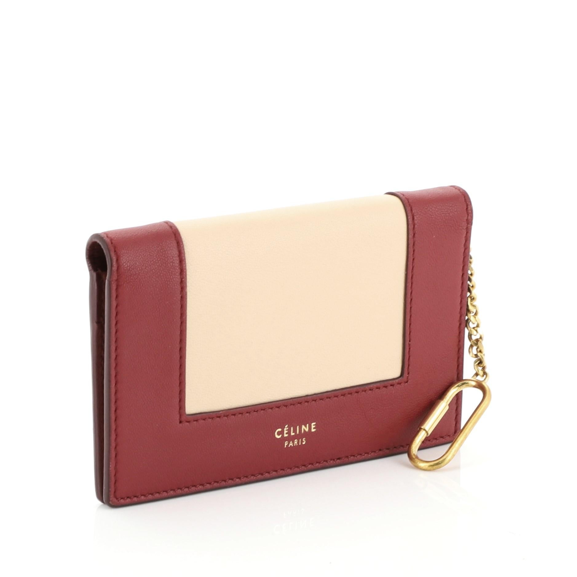 This Celine Frame Coin Purse Leather, crafted in red leather, features a full frontal flap with snap button closure and gold-tone hardware accents. It opens to a red leather interior with multiple card slots, zip pocket and slip pockets 

Estimated