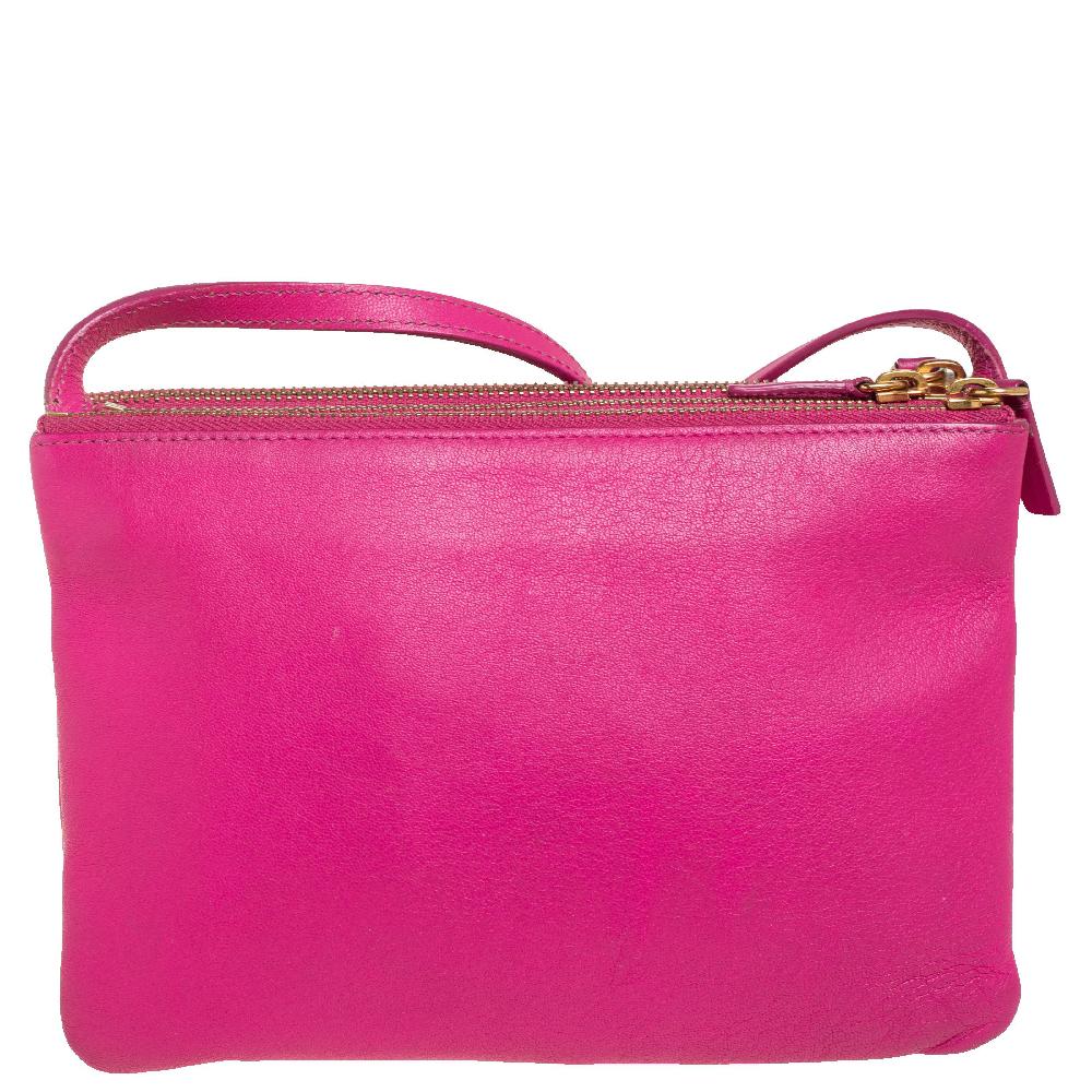 A compact crossbody bag can assist you with many outings and can be styled with most of your attires. Céline's bag is an example of the label’s penchant for creating staple pieces. It is crafted from leather in a fuchsia shade and features three