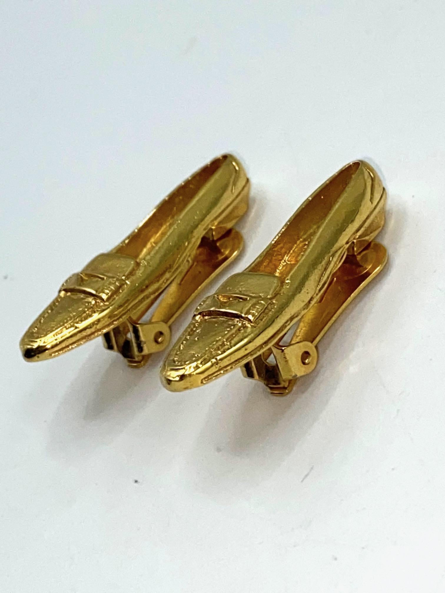 A unique pair of Celine earrings in the form their loafer style shoe from 1992. Each earring is cast with details of the top raised stitching around the toe and the horizontal saddle that sits across the top. Additionally, the heal sole and heal are