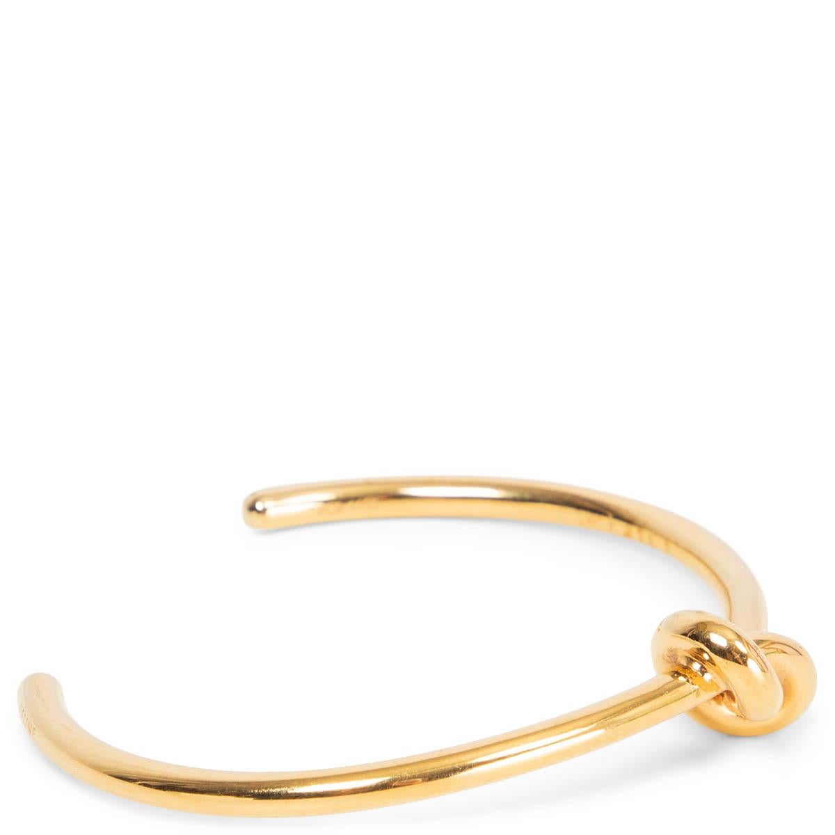 100% authentic Céline Extra Thin Open Knot Bracelet in gold-plated brass. Brand new. Comes with dust bag and box. 

All our listings include only the listed item unless otherwise specified in the description above.