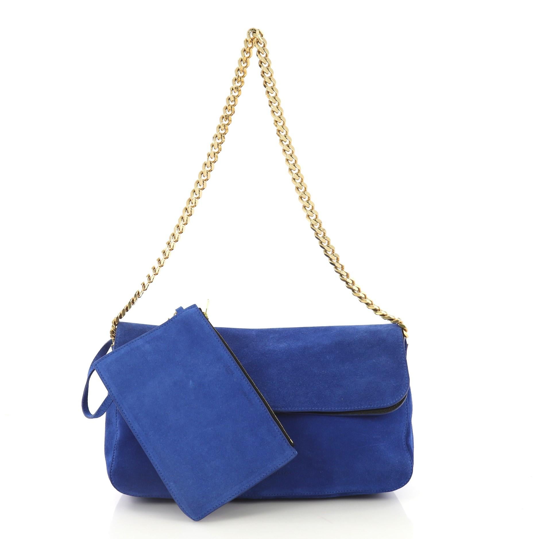 This Celine Gourmette Shoulder Bag Suede Small, crafted from blue suede, features chain strap and gold-tone hardware. Its flap opens to a black leather interior slip pockets. 

Estimated Retail Price: $2,300
Condition: Very good. Loss of shape,
