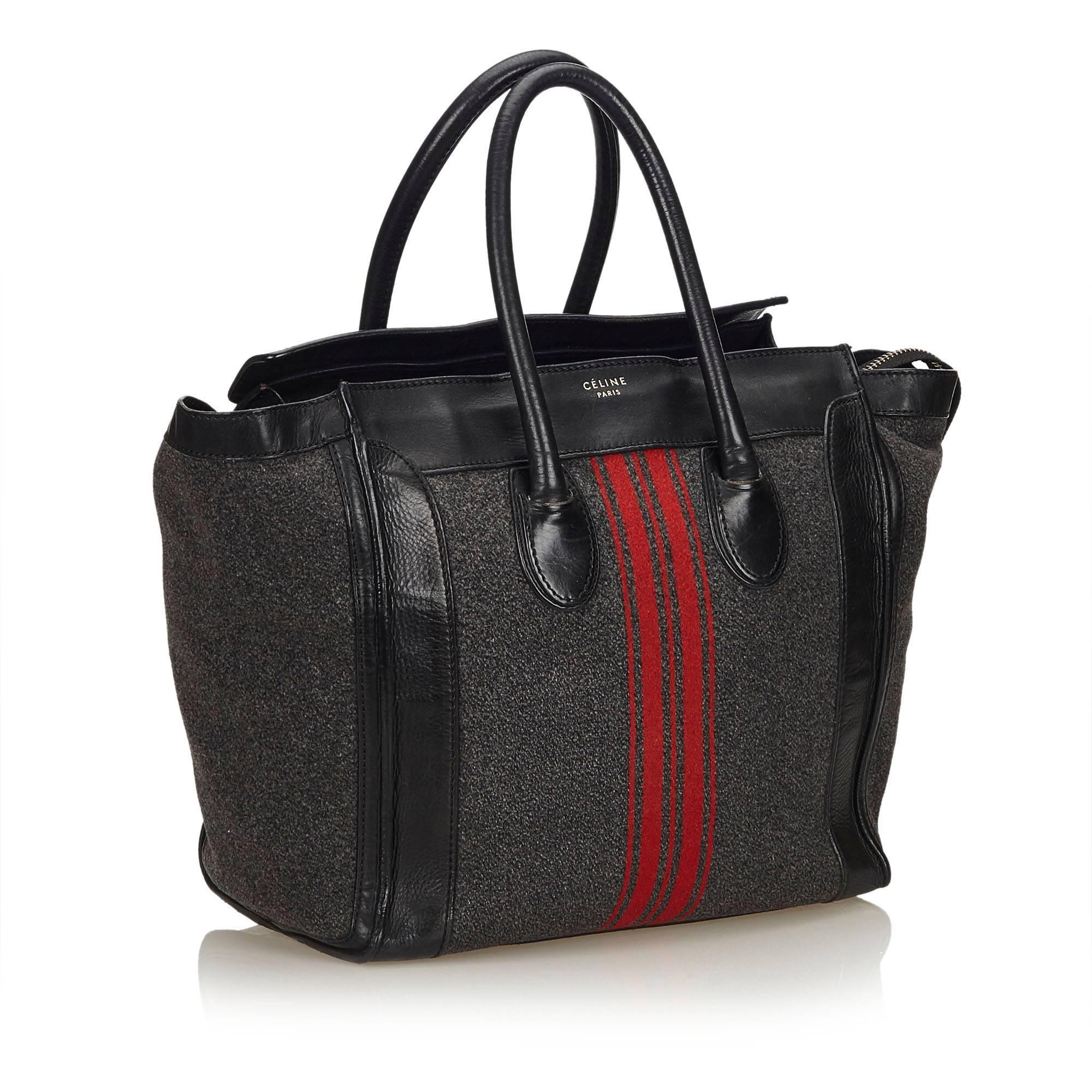 The Medium Luggage features a wool body with leather trim, stripes detail, rolled leather handles, top zip closure, and interior zip pocket. 

It carries a B condition rating.

Dimensions: 
Length 32 cm
Width 29 cm
Depth 18 cm
Hand Drop 13