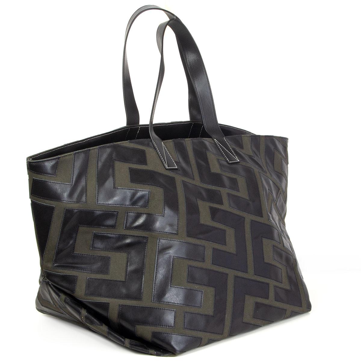 Céline by Phoebe Philo patchwork bicolor tote bag in dark olive green canvas and black calfskin. Lined in dark olive canvas featuring black detachable calfskin pouch/clutch. Has been carried and is in excellent condition. Comes with dust bag.