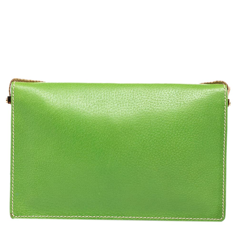 Add a pop of color to your closet with this exquisite Celine clutch. The exterior is crafted from green leather and flaunts gold-toned details. The clutch is made in a flap style which opens up to spacious, fabric-lined compartments to carry your