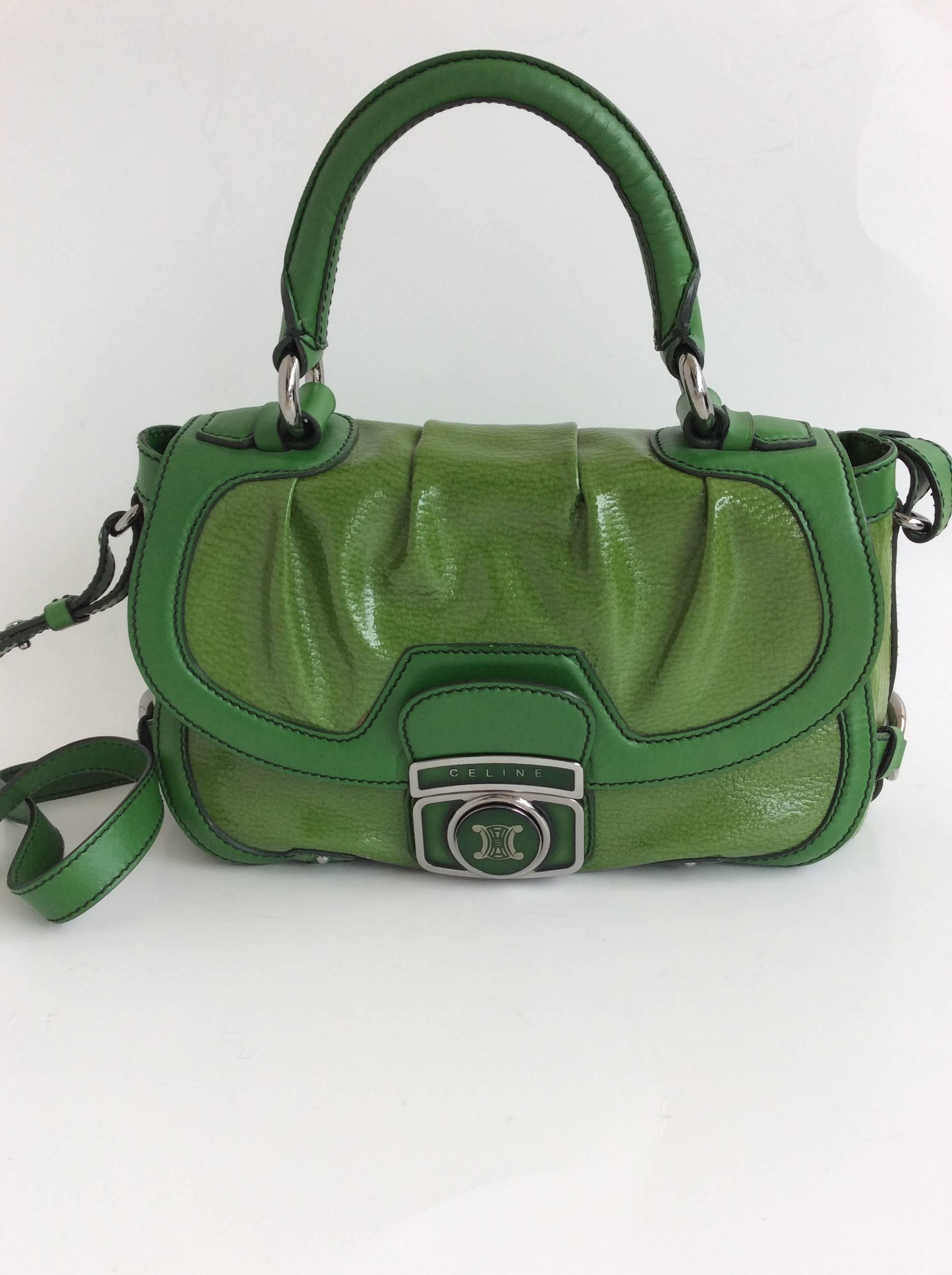 Shamrock green Celine patent leather satchel with silver toned hardware. Celine logo at front, single pocket under front flap, three interior pockets, push-lock closure at front. Soft leather trim throughout. Adjustable shoulder strap attached.