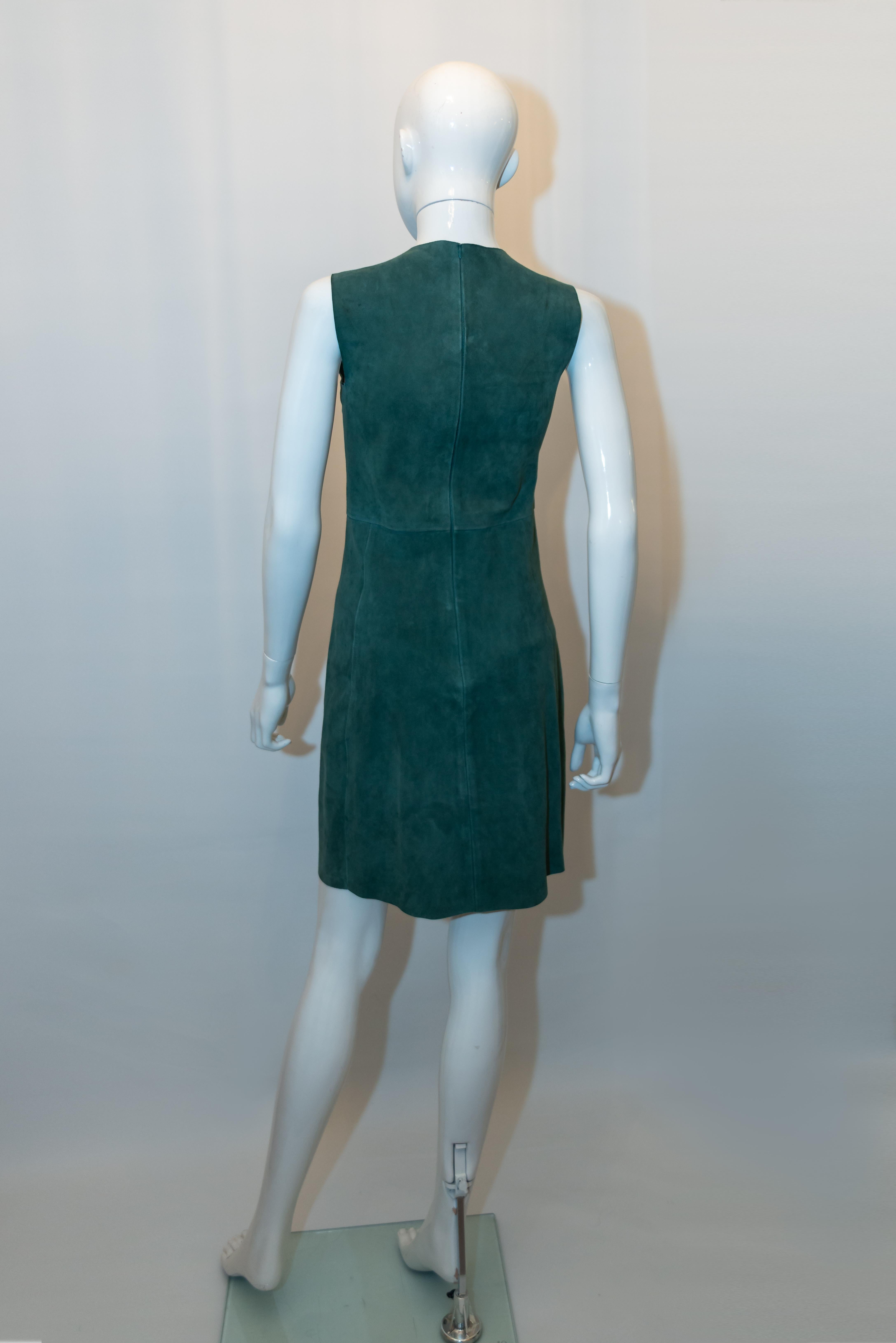 A chic green suede dress by Celine. The shift dress has a central back zip, and flared skirt . 
Size 36 Measurements: Bust 33;'' ( may give a bit) , length 36''