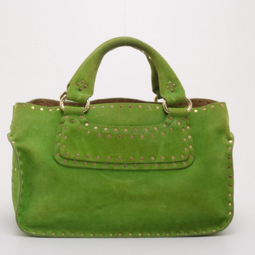 Fall in love with this beautifully colored Studded Boogie bag by Celine. Crafted from green suede, it is given an edgy finish with flat gold studs, wide contrast stitching, double handles and gold tone hardware. The interior is lined with beige