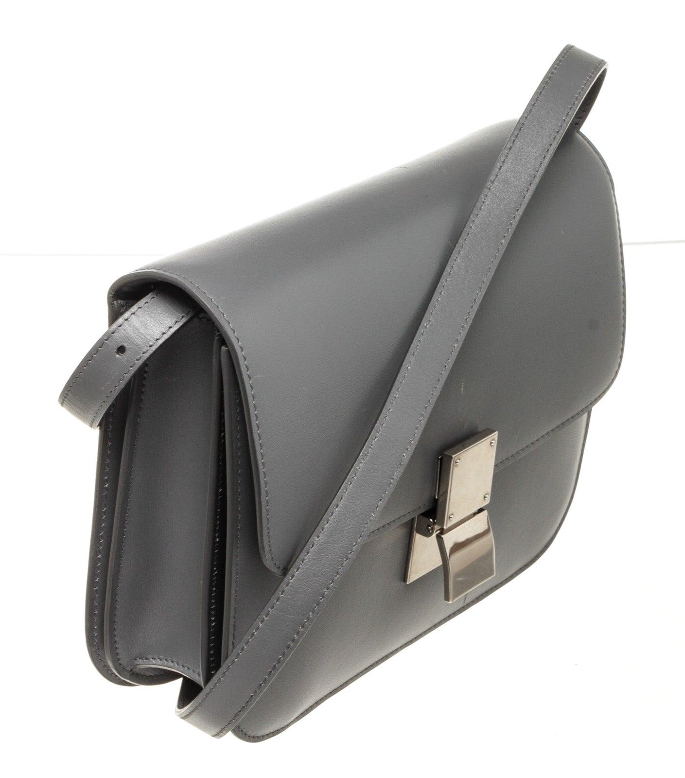 Celine Grey Leather Classic Medium Shoulder Bag with leather, gold-tone hardware, trim tan vachetta leather, interior slip pocket, shoulder strap and push lock closure.
48593MSC