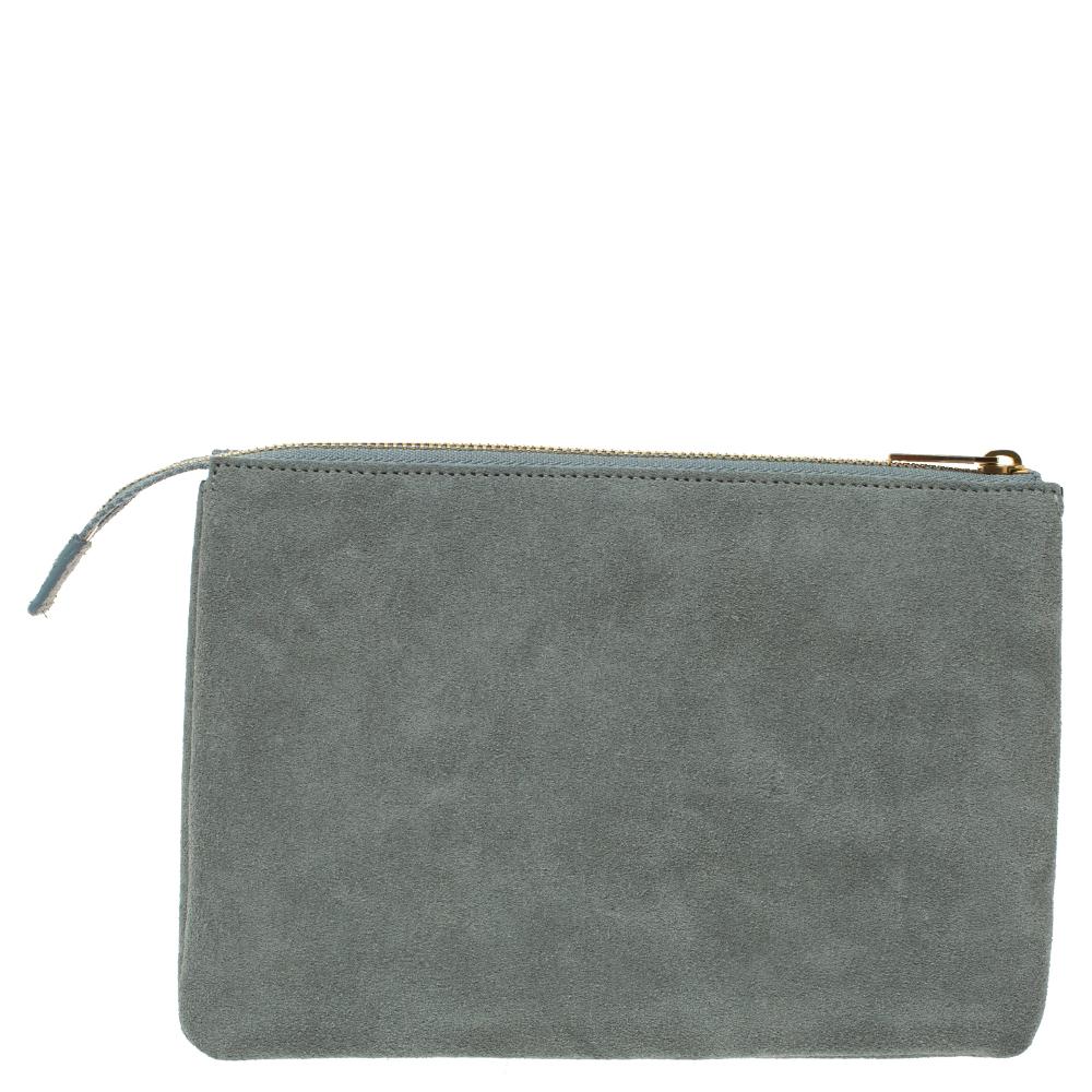 Crafted from suede, this clutch by Celine comes in a lovely shade of grey. It flaunts a simple silhouette and exudes sophistication. The zip clutch has three compartments with ample space for your necessities. The exterior features the brand
