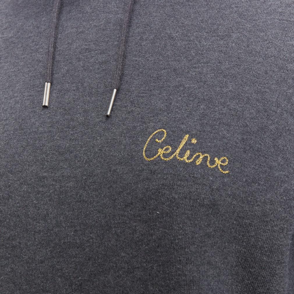 CELINE Hedi Slimane grey 100% cotton gold lurex embroidery hoodie sweatshirt L
Reference: KEDG/A00331
Brand: Celine
Designer: Hedi Slimane
Material: Cotton
Color: Grey, Gold
Pattern: Solid
Closure: Pullover
Made in: Italy

CONDITION:
Condition: