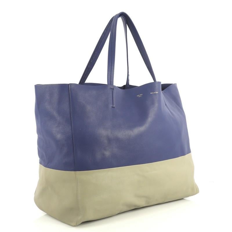 This Celine Horizontal Cabas Tote Leather Large, crafted in blue and gray leather, features dual flat leather handles, stamped Celine logo at the center, and gold-tone hardware. Its wide open top showcases a blue and gray raw leather interior with