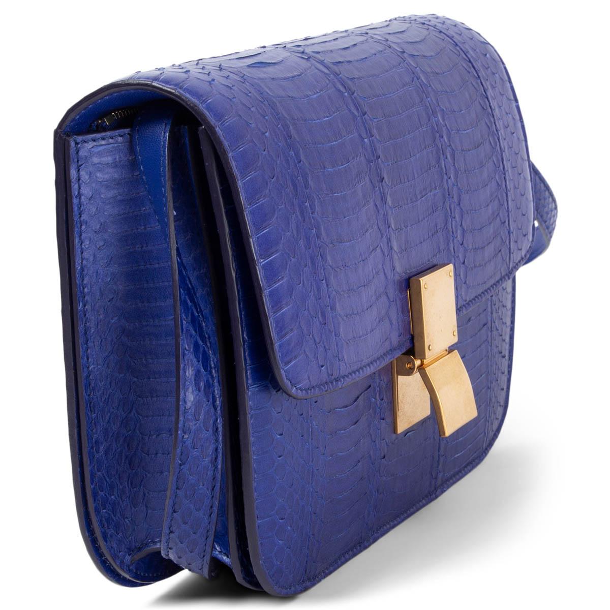 100% authentic Céline Medium Classic Bag in Indigo (purple blue) pithon featuring gold-tone hardware. Opens with a push-lock on the front. The inside is divided into two compartments with two open pockets against the front and a zipper pocket
