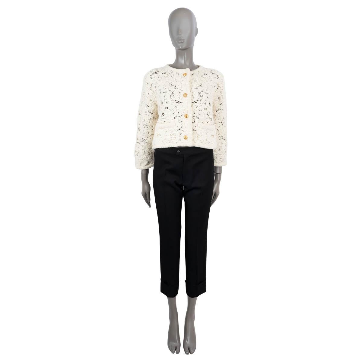 100% authentic Celine cornelly crochet jacket in ivory alpaca (62%), polyamide (21%), mohair (9%) and wool (8%). Features a crewneck, braided trim and two welt pockets. Closes with four gold-tone Celine Blason buttons. Unlined. Has been carried and