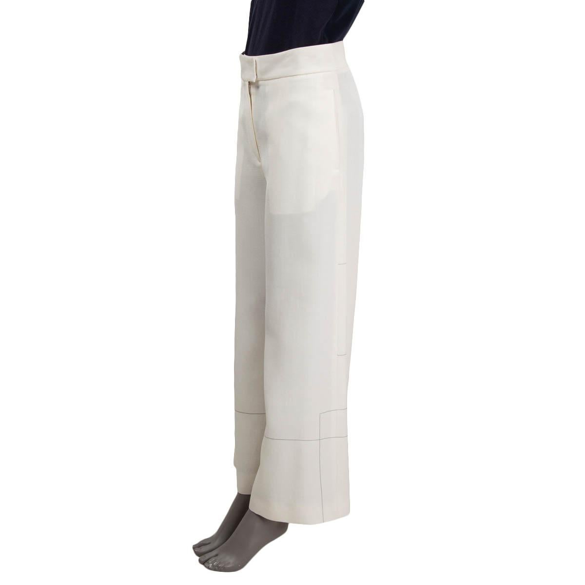 100% authentic Céline by Phoebe Philo wide-leg pants in ivory viscose (57%) and silk (43%). Features thin stripe print, two pockets on the sides, and one buttoned welt-pocket on the back. Opens with a concealed zipper and two hook on the front.