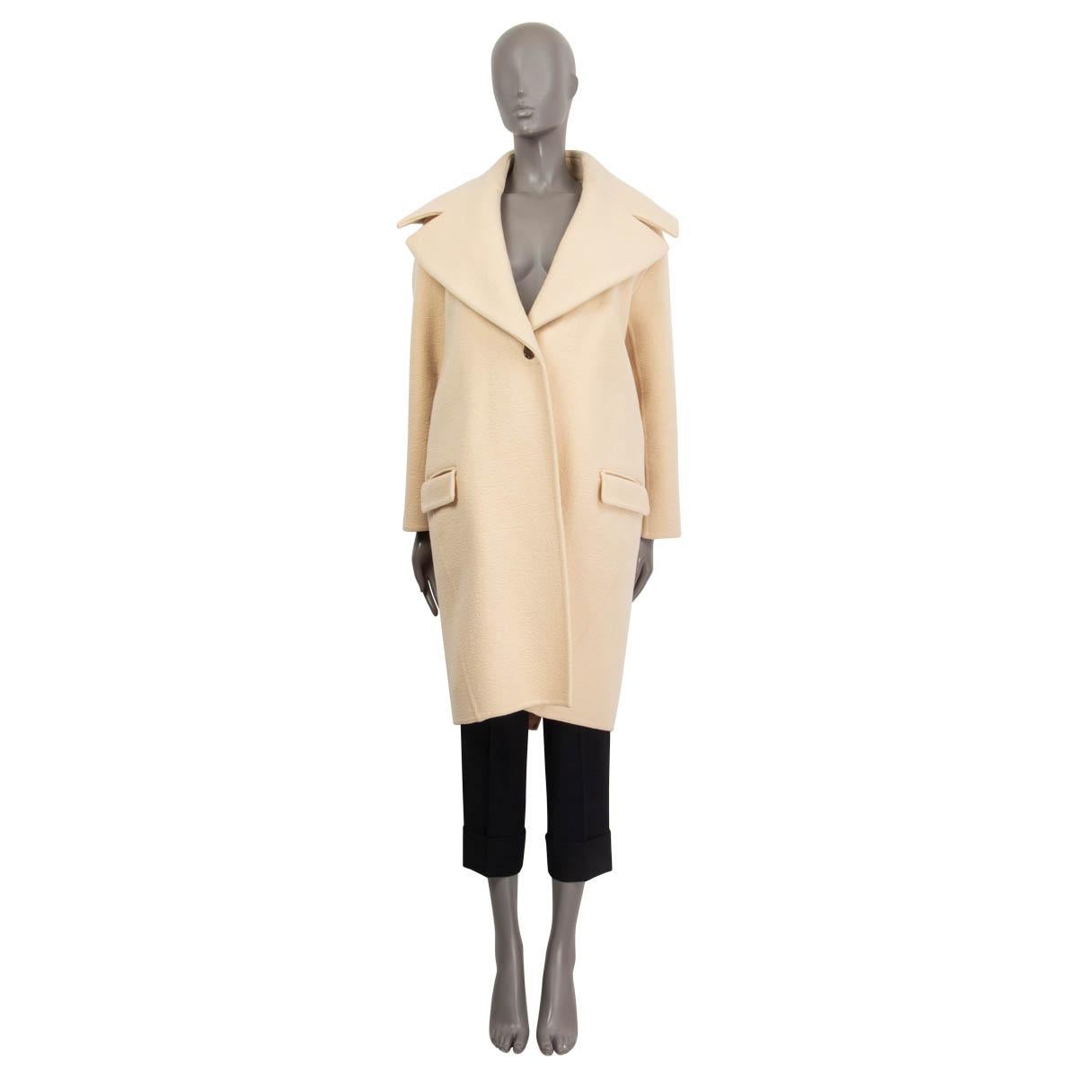100% authentic Céline by Phoebe Philo back-belted coat in ivory cashmere (100%). Fall/winter 2013. Features a wide collar, two slit pockets on the front and an oversized fit. Opens with one gold-tone button on the front. Sleeves and pockets lined in