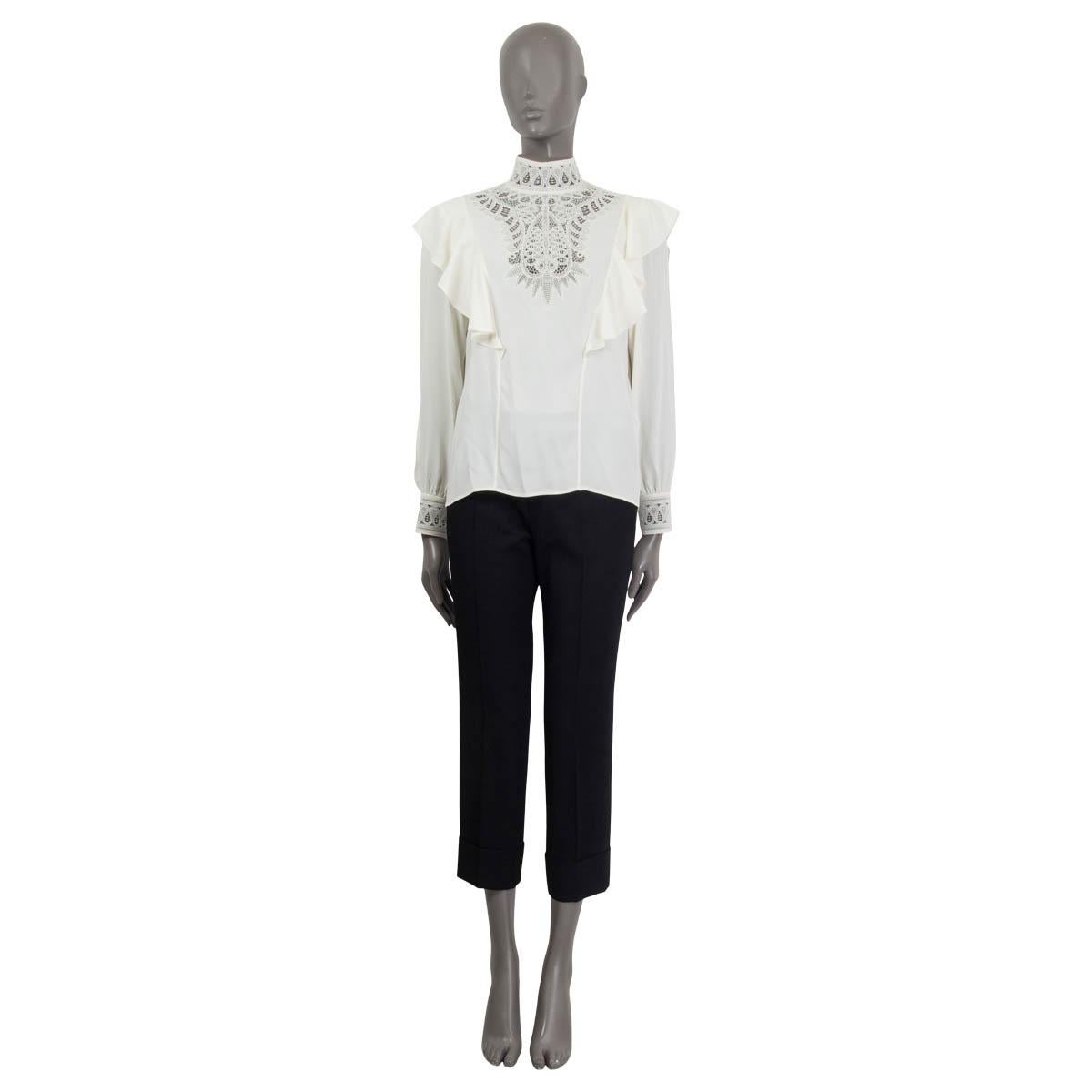 100% authentic Celine long sleeve blouse in off-white acetate (64%) and silk (33%). Comes with crochet lace on the neck, the front and the buttoned cuffs. Embroidery with ruffles on the front and the back. Opens with a hook and a concealed zipper on