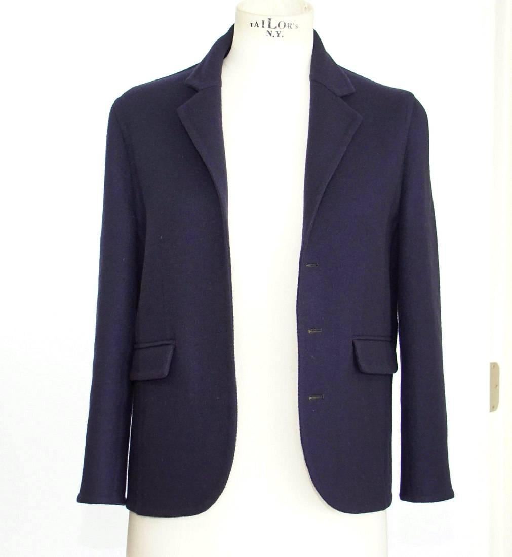 Guaranteed authentic Celine beautifully cut uniquely styled navy cashmere jacket.
3/4 Sleeve narrow cut 3 button single breast with interior button placket.
2 flap pockets.
Vented cuffs and rear.
Jacket is lined in silk.
Fabric is cashmere.
NEW or