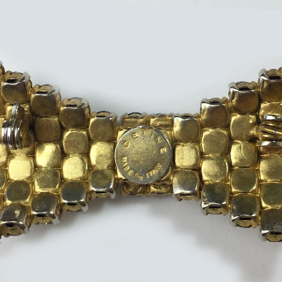 Women's or Men's Celine Knot Vintage Brooch In Gold Metal And Rhinestones