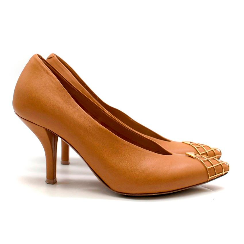 Celine Leather Cage Toe Pumps

- Camel, soft leather pump
- Pointed toe, with gold-tone cage embellishment 
- 70 stiletto heel
- Nude leather insole, with shiny gold Celine logo insole
- Brown leather sole
- This item comes with the original dust