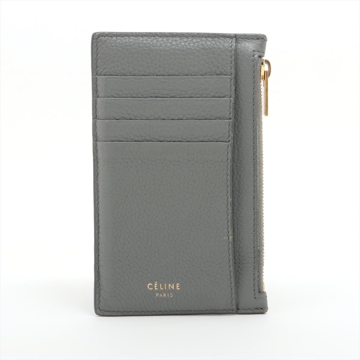 The Celine Leather Coin Card Wallet in gray is a sleek and compact accessory designed for minimalist functionality. Crafted from high-quality leather, it features a streamlined silhouette that can easily fit into small bags or pockets. The wallet