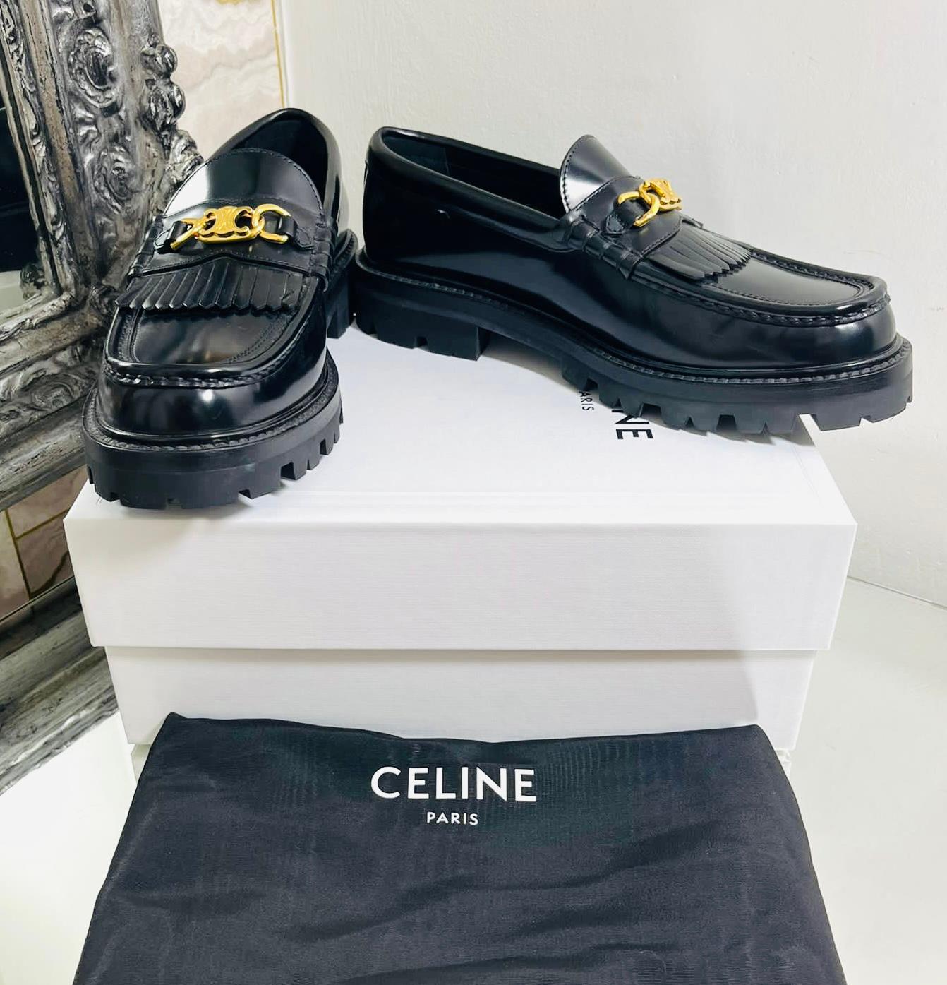 Celine Leather Margaret Loafers

Black slip-on loafers designed with the brand's signature gold Triomphe logo chain to the vamp.

Featuring leather fringe detailing and rubber lug outsoles, leather insoles. Rrp £830

Size – 40.5

Condition –